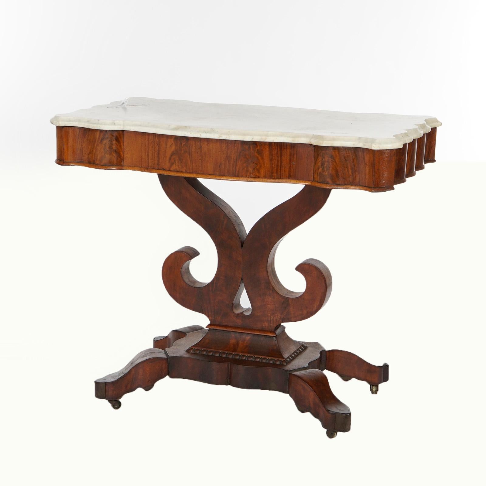 An antique American Empire Classical Greco center table offers beveled and shaped marble top over double scroll base raised on stylized cabriole legs, c1840

Measures- 29.75''H x 35.5''W x 20.25''D.