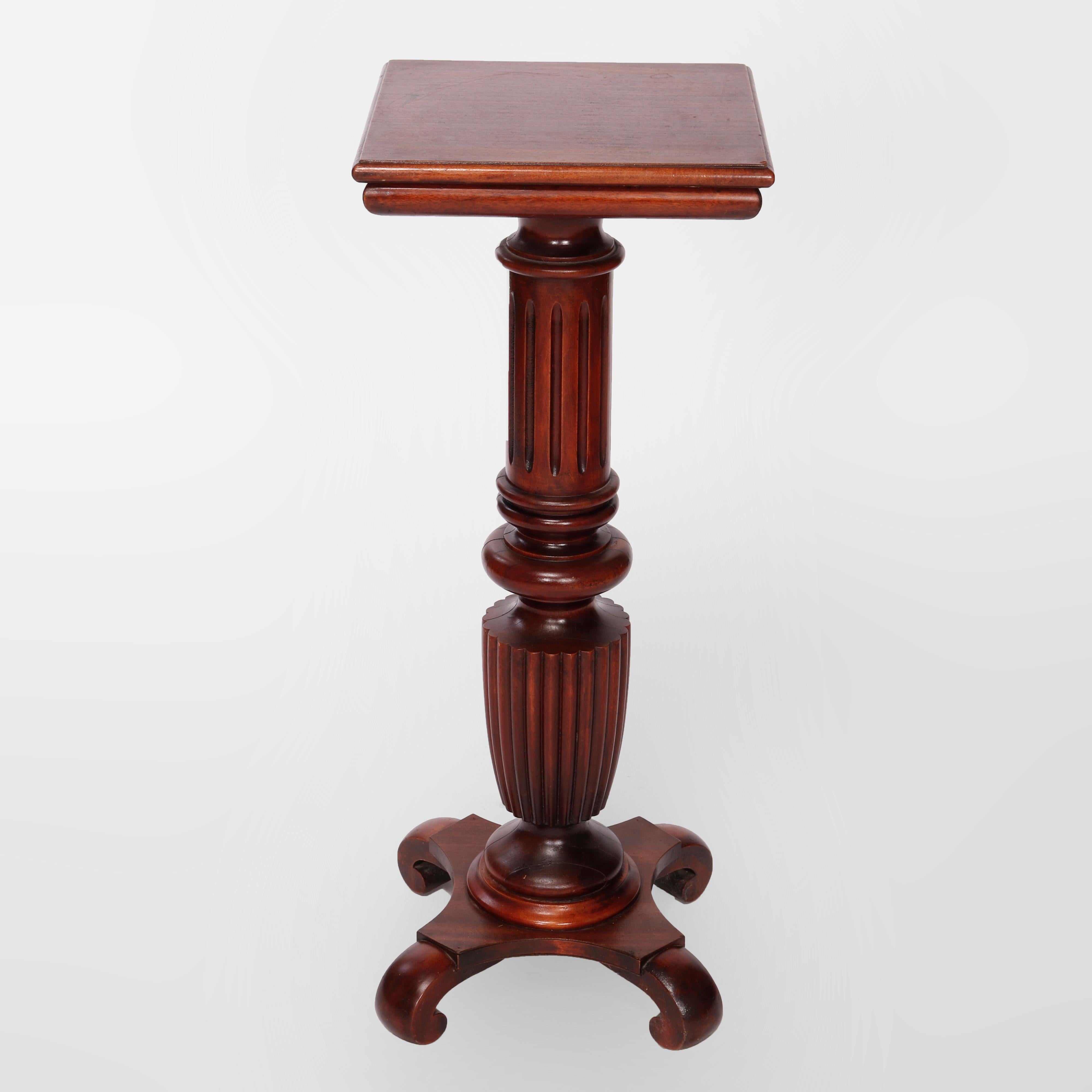 An antique Classical sculpture pedestal offers carved mahogany construction with square display over reeded column having stylized urn form element raised on base with scroll form feet, c1900

Measures- 36'' H x 14'' W x 14'' D.

Catalogue Note: Ask