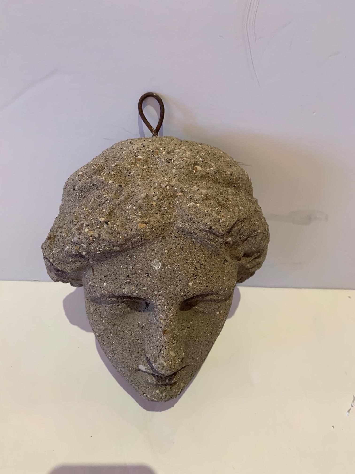 An unexpectedly beautiful hanging wall sculpture of the beautiful Diana's face made from cast stone.