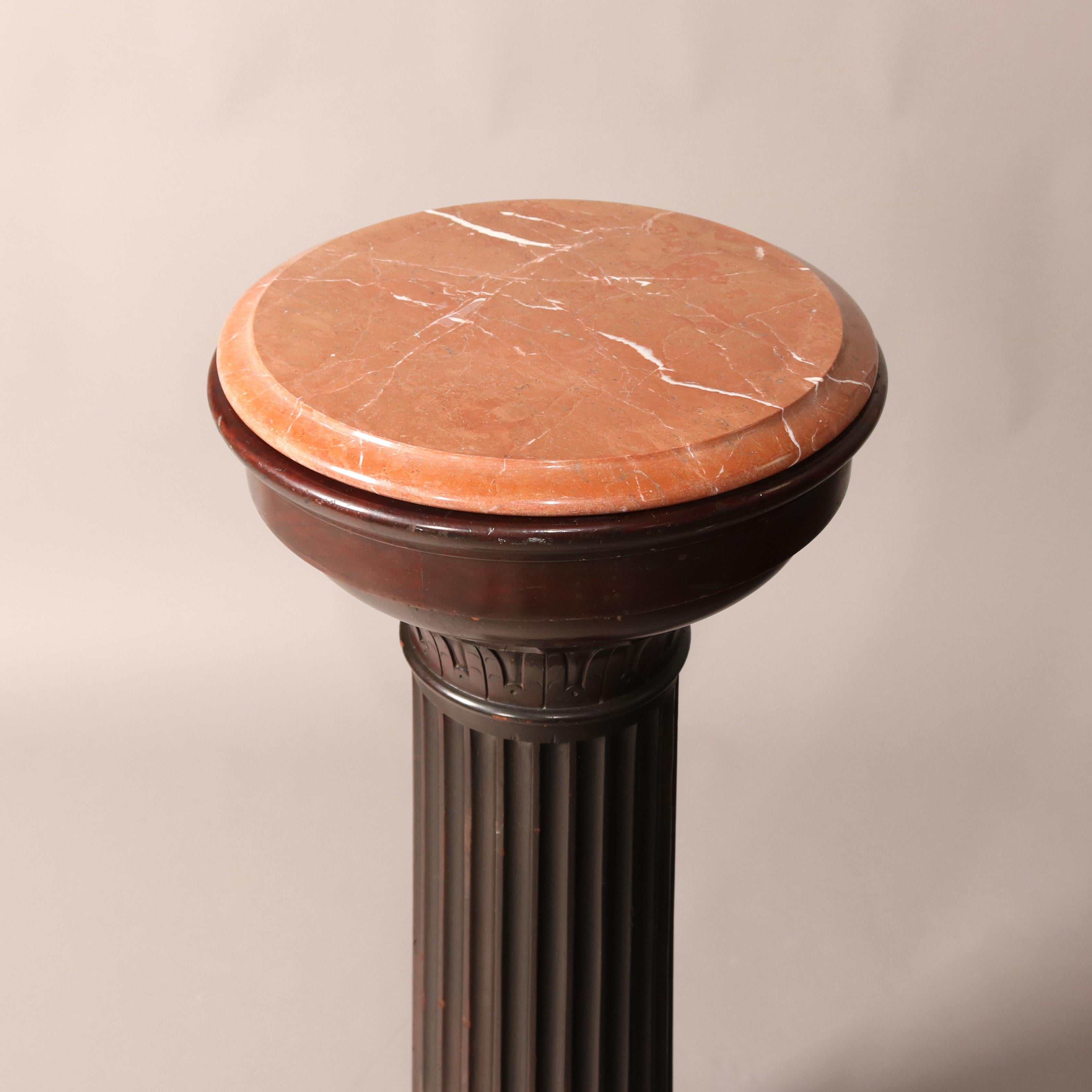 An antique carved dark mahogany pedestal features beveled marble display surmounting Classical Greek Doric form pedestal with reeded column and seated on square base, c1890

Measures - 38.75