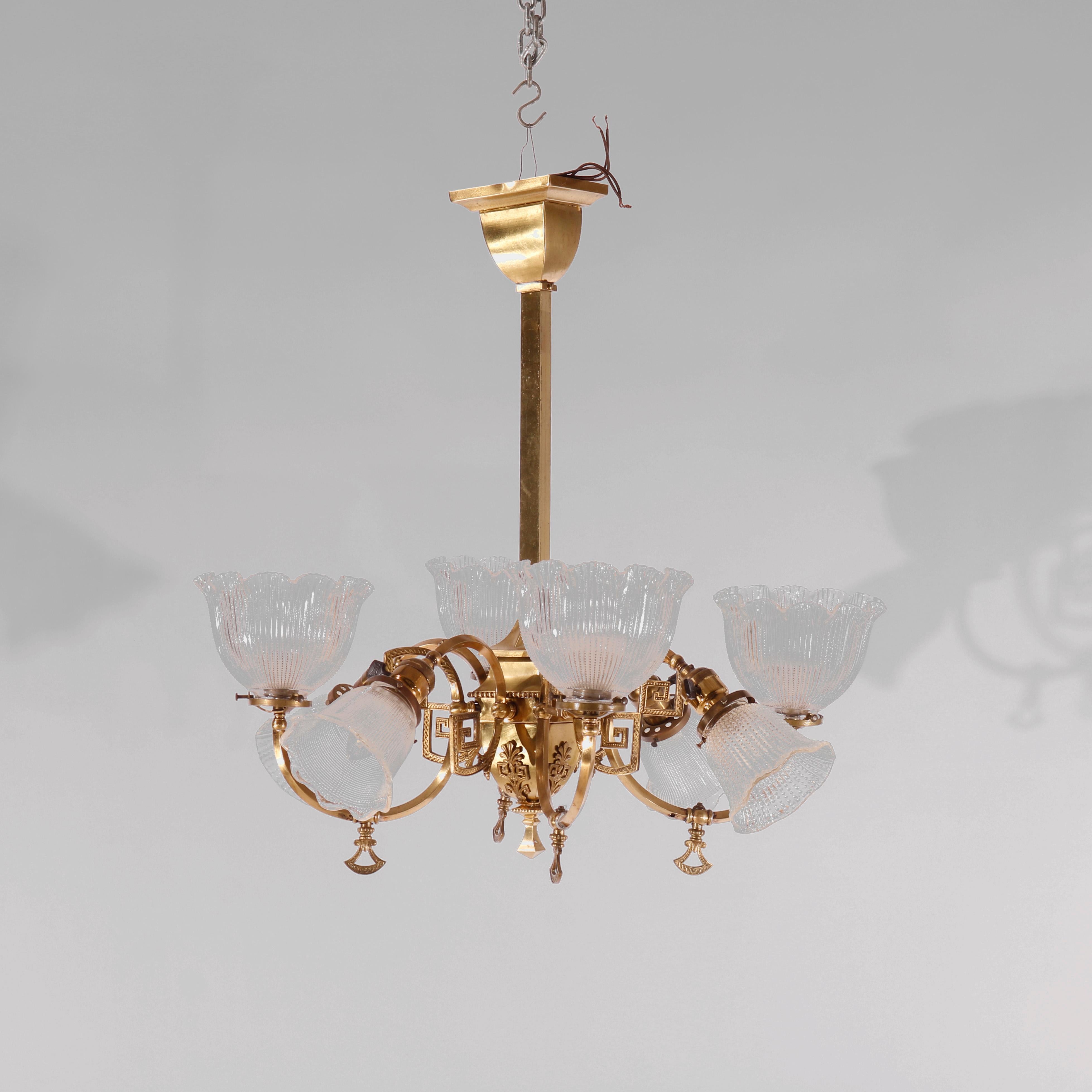 An antique up-and-down hanging fixture offers gilt brass frame with Classical elements including Greek Key design, four up-lights and four down-lights, c1930

Measures - 26