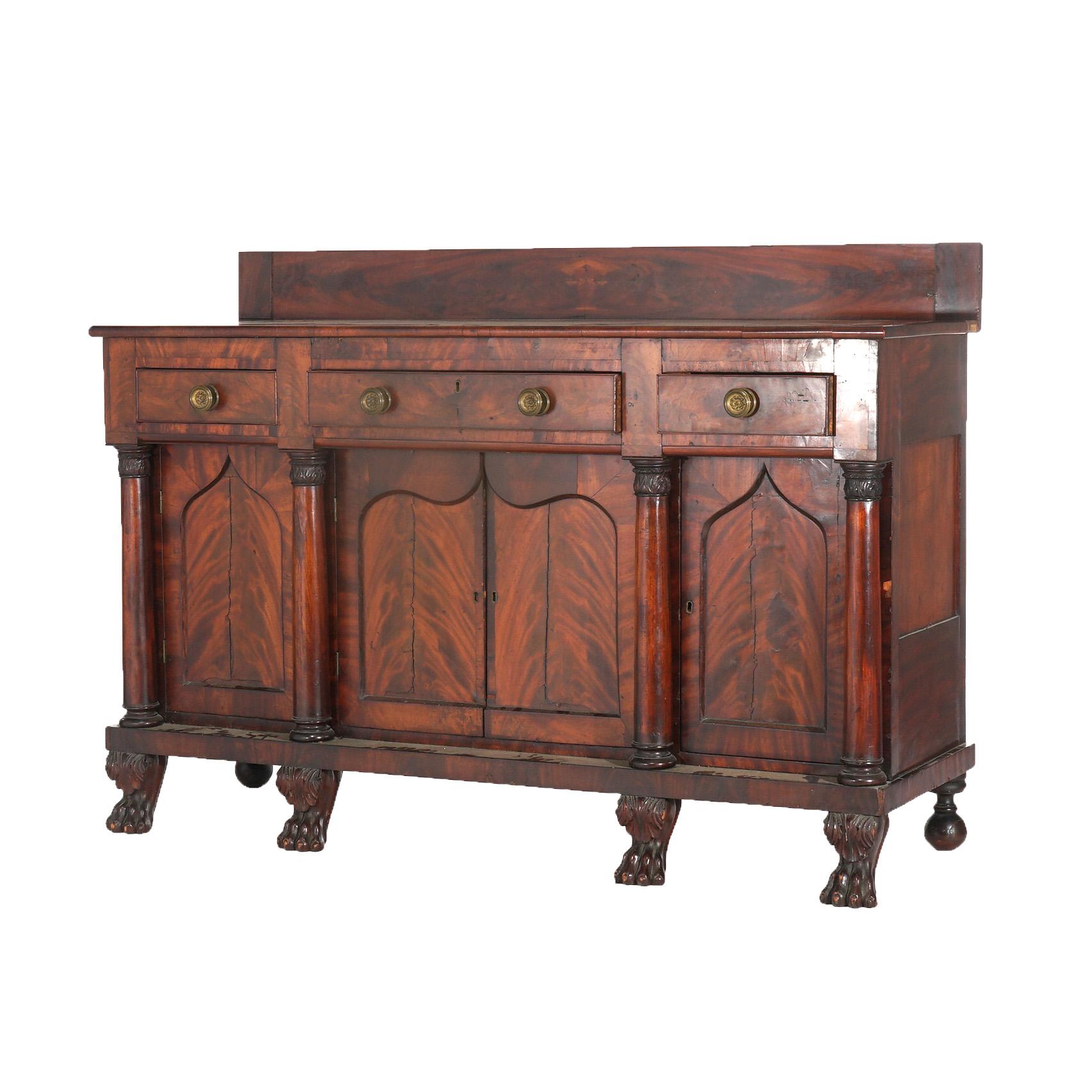 ***Inquire About Reduced In-House Delivery Rates - Reliable Professional Service & Fully Insured***

Antique Classical Gothic Revival Carved Flame Mahogany Paw Foot Sideboard with Three Frieze Drawers over Lower Cabinets having Cathedral Arch Inset