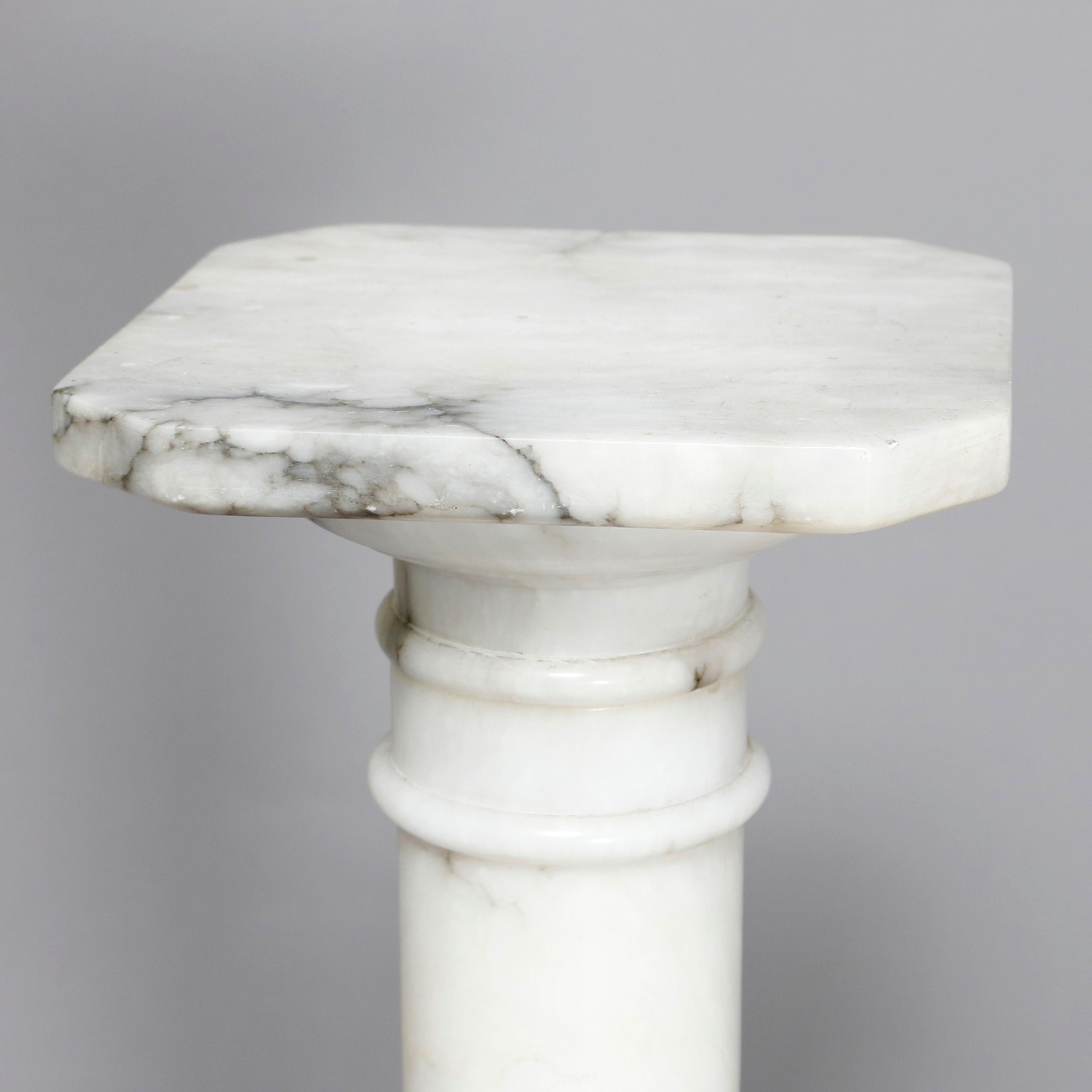 An antique Classical Italian carved marble sculpture pedestal offers Doric column-form with octagonal and stepped base and clipped corner display, 20th century

Measures: 35