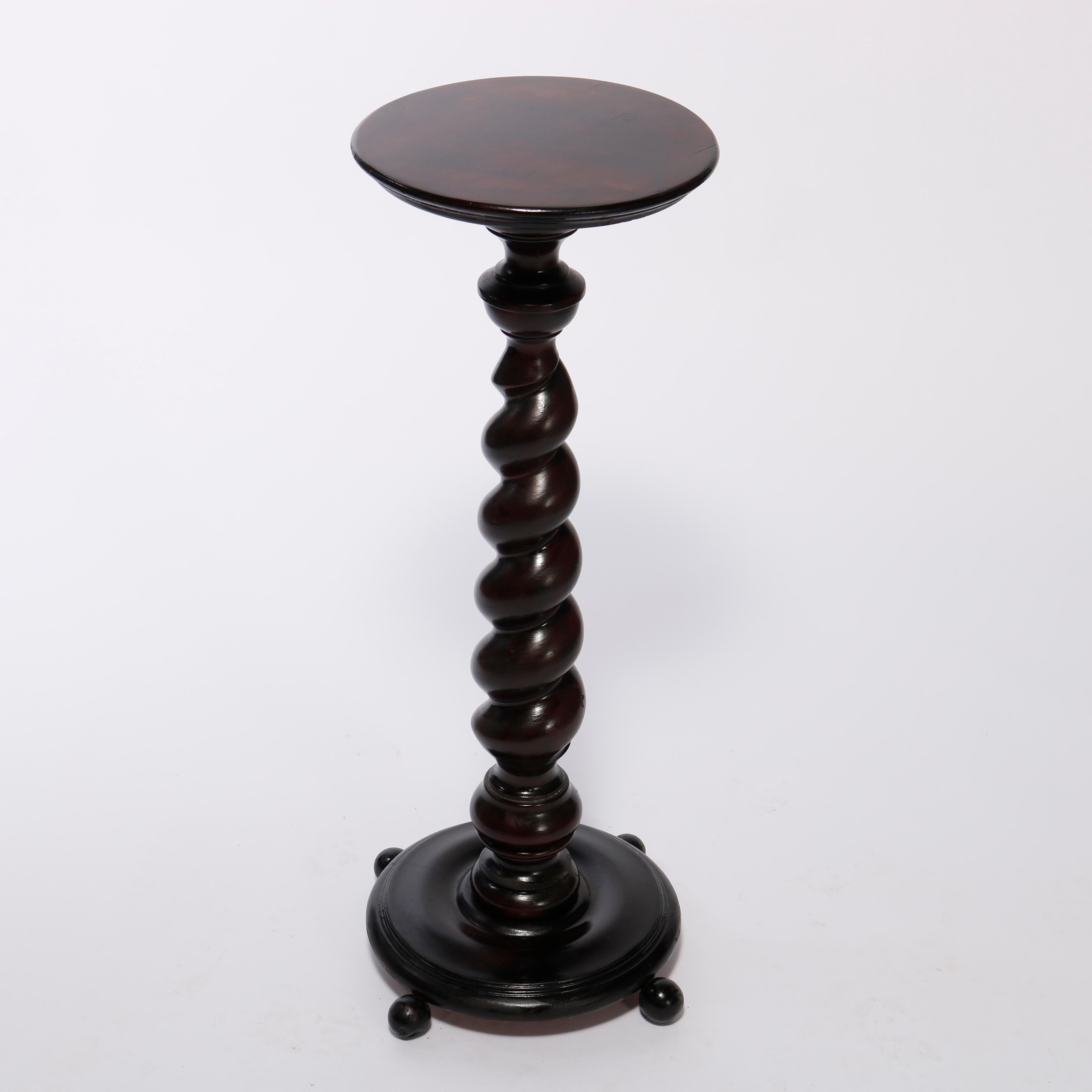 An antique Classical sculpture pedestal offers carved mahogany construction with circular display over rope twist column and seated on base with ball feet, c1910

Measures - 36.25''H x 15.75''W x 15.75''D.

Catalogue Note: Ask about DISCOUNTED