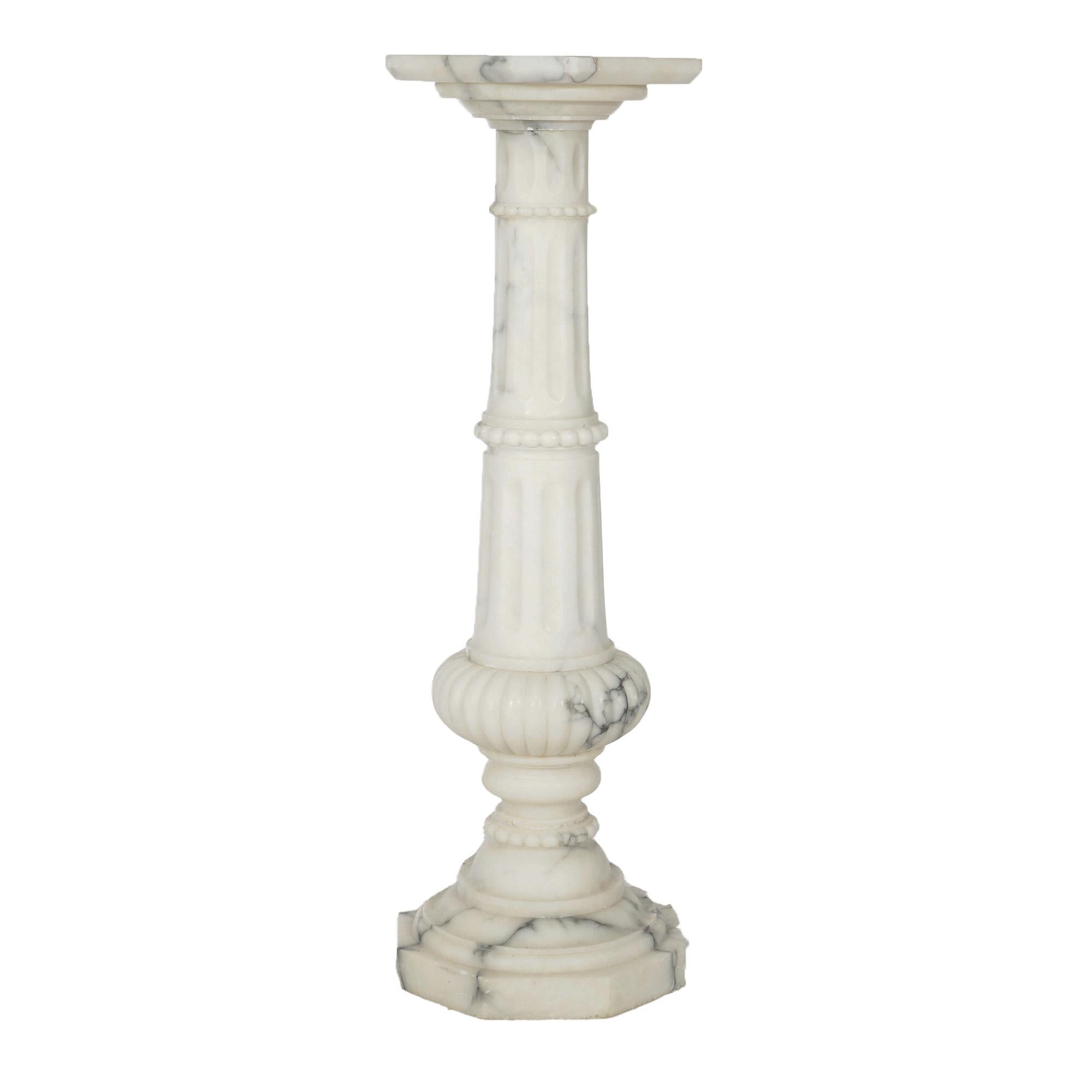 An antique Classical sculpture display pedestal offers marble construction with clip-corner display platform over reeded column having melon form element, circa 1890

Measures - 42.75