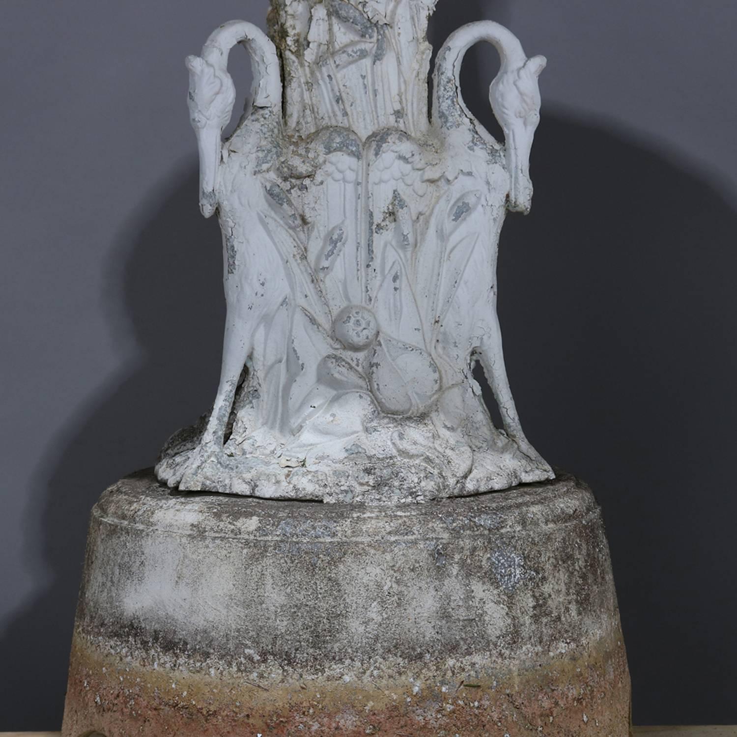 Antique Classical cast metal garden fountain features four-tiered graduated scalloped bowls with acorn finial and raised on triple swan base, painted, circa 1900

Measures: 100