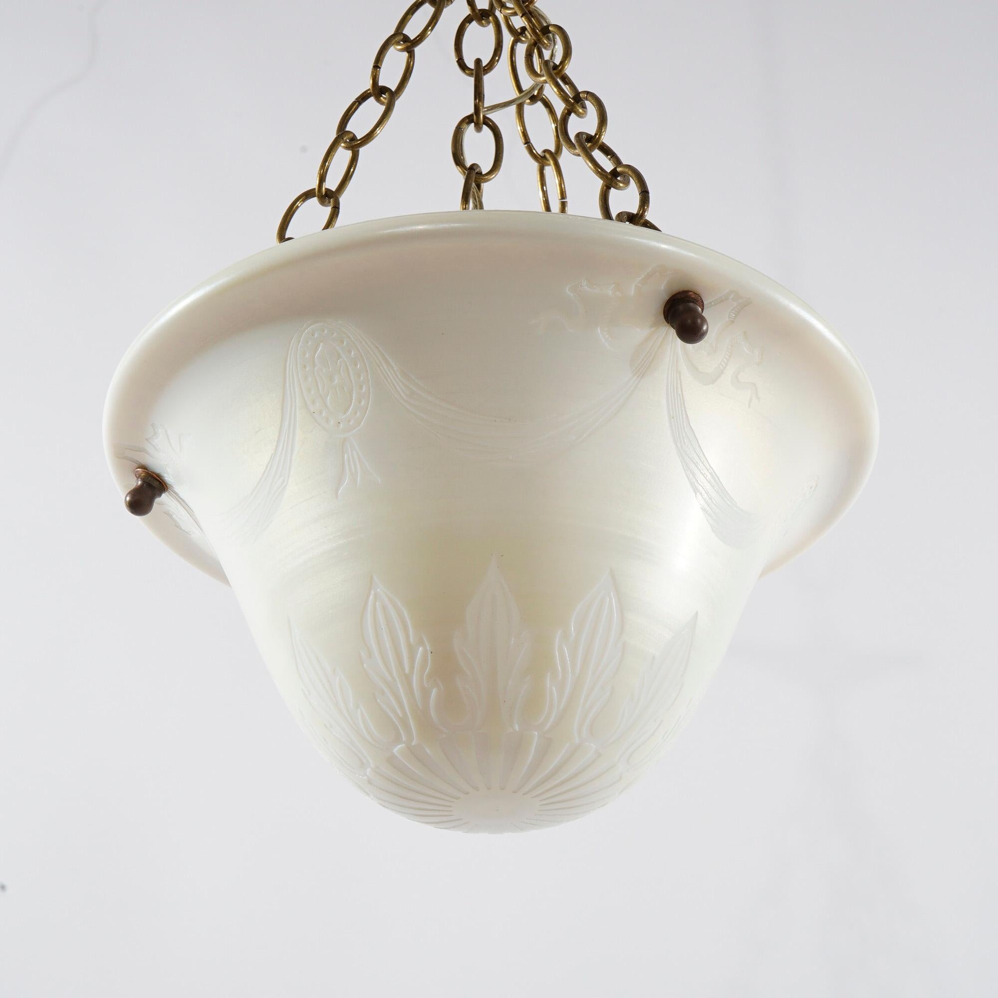 An antique pendant light offers single socket light with drop pendant having art glass calcite etched shade with swag and foliate design, c1920

Measures- 20'' H x 11.75'' W x 11.75'' D; 7'' drop.