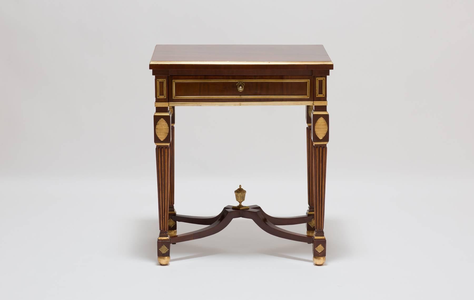 A very elegant antique Russian table from the 18th century. The table is made from mahogany wood and is fitted with typically brass borders. The antique table has one drawer at the front. Raised on square tapering legs joined by an X-form stretcher