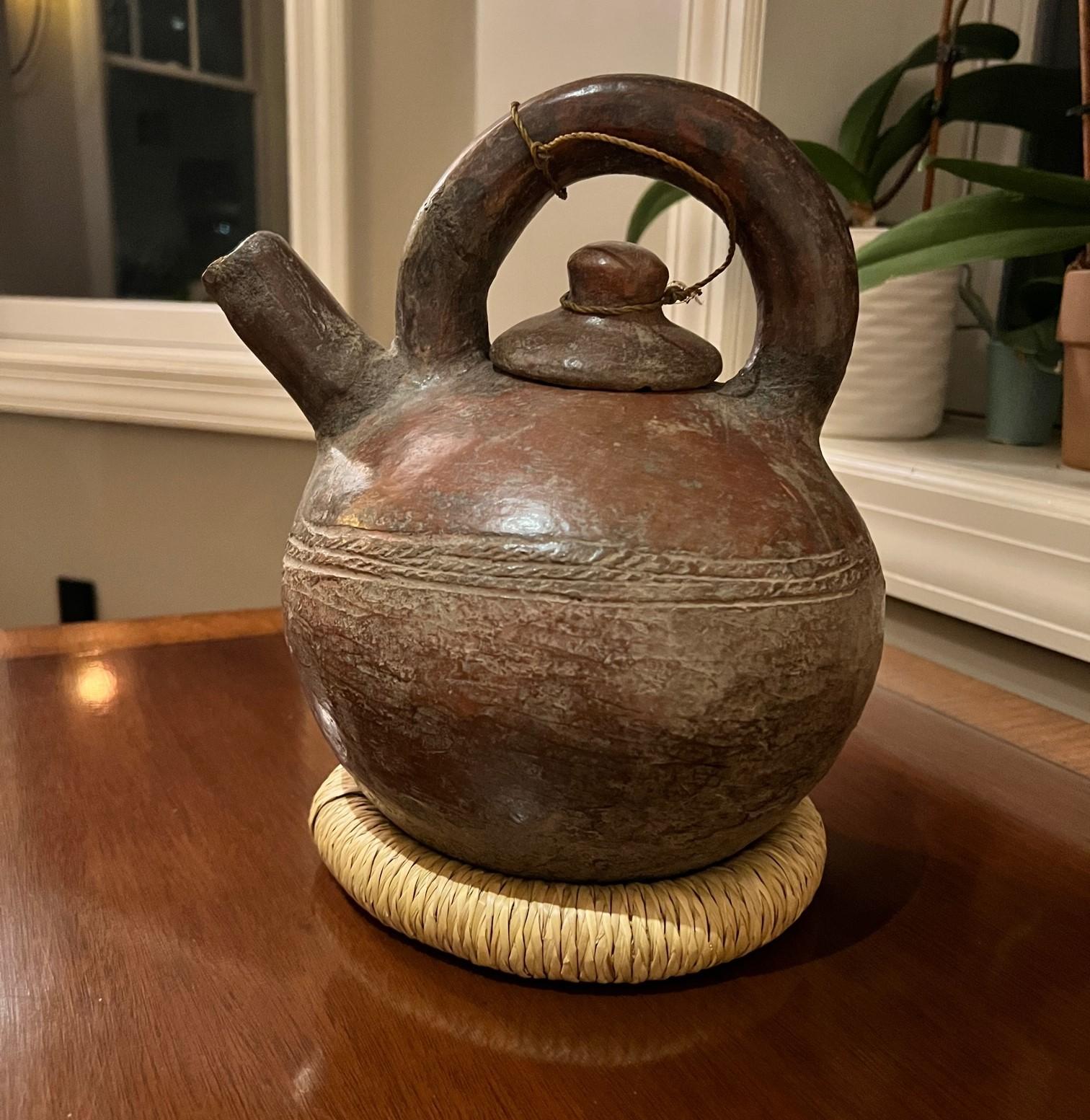 Early 20th Century fired clay water pot with lid from the Gurunsi peoples of Burkina Faso. Shaped much like a teapot, this lidded water pot is beautifully crafted with a band of surface decoration showing attention to pattern and texture, Ceramics