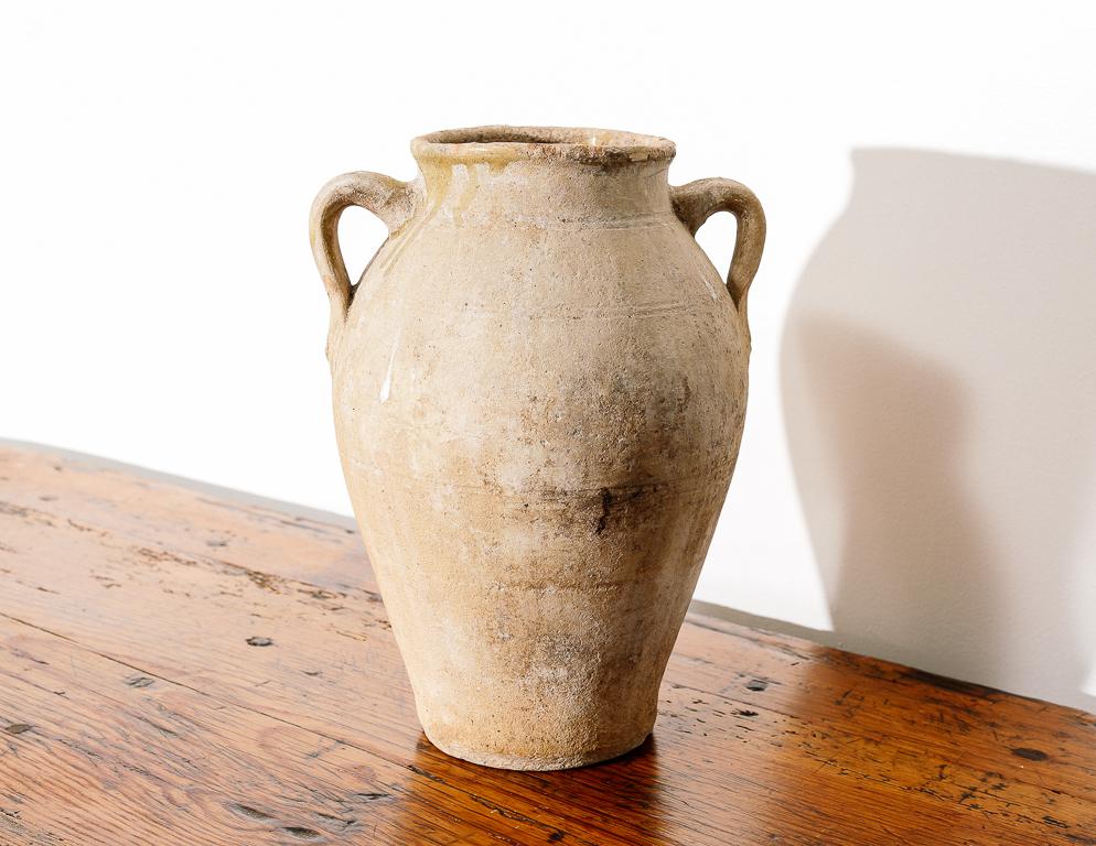 Antique clay amphora with two handles.