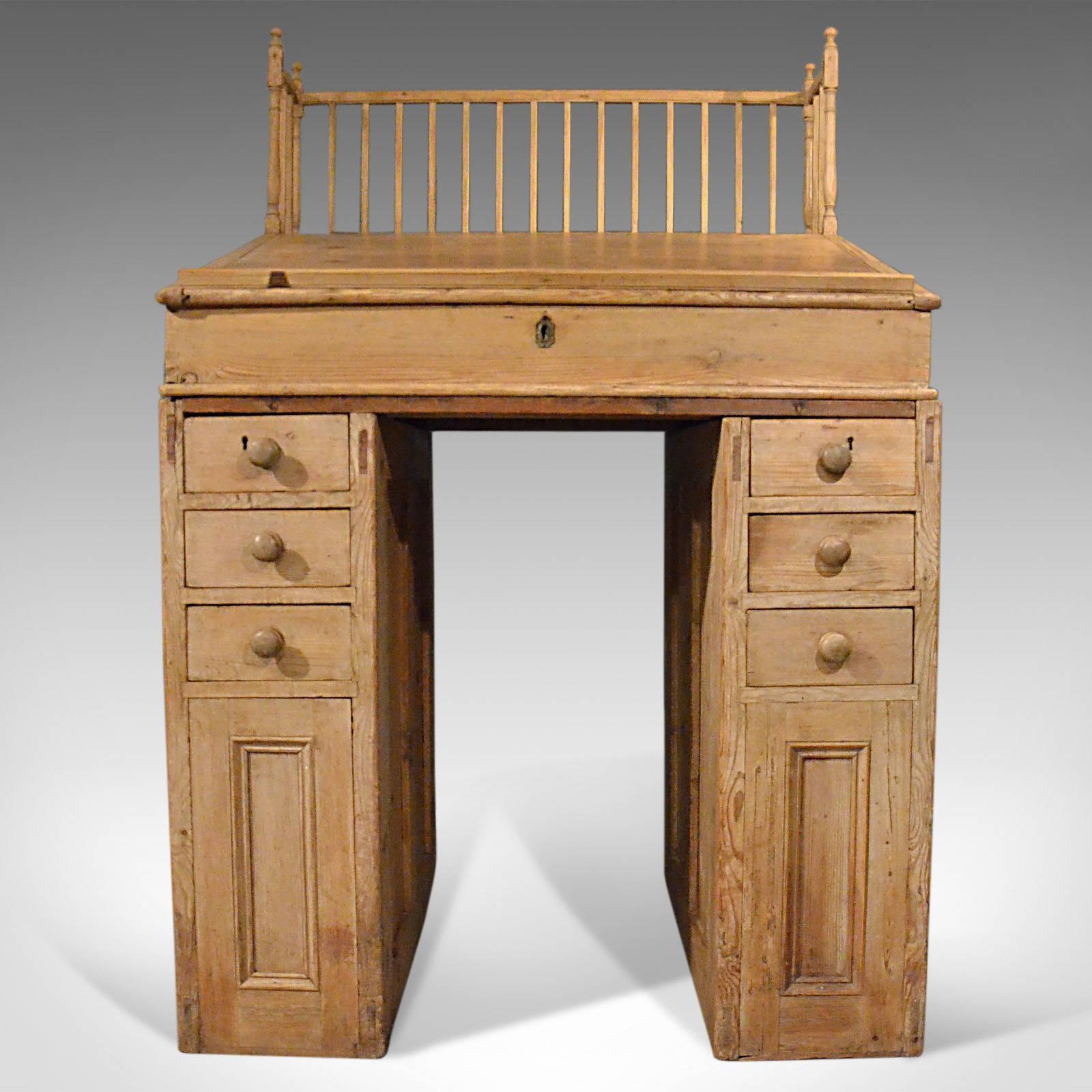 This is an antique clerks desk, an English, Victorian, pine bureau from the late 19th century circa 1900.

Classic English styling in aged pine with a very desirable tone
Attractive proportions – can be used with a stool or as a standing