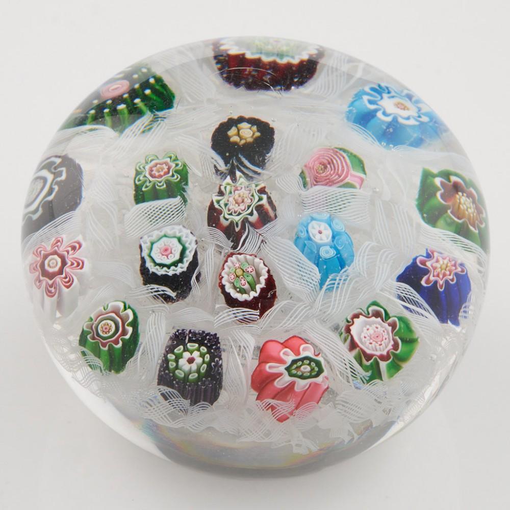 Heading : An Antique Clichy Rose Millefiori Chequer Paperweight c1850
Date : c1850
Origin : France
Features : Eighteen complex millefiori canes inc Clichy rose chequer boarded within a white latticino bed
Marks : None
Type : Lead
Size : 7.0cm