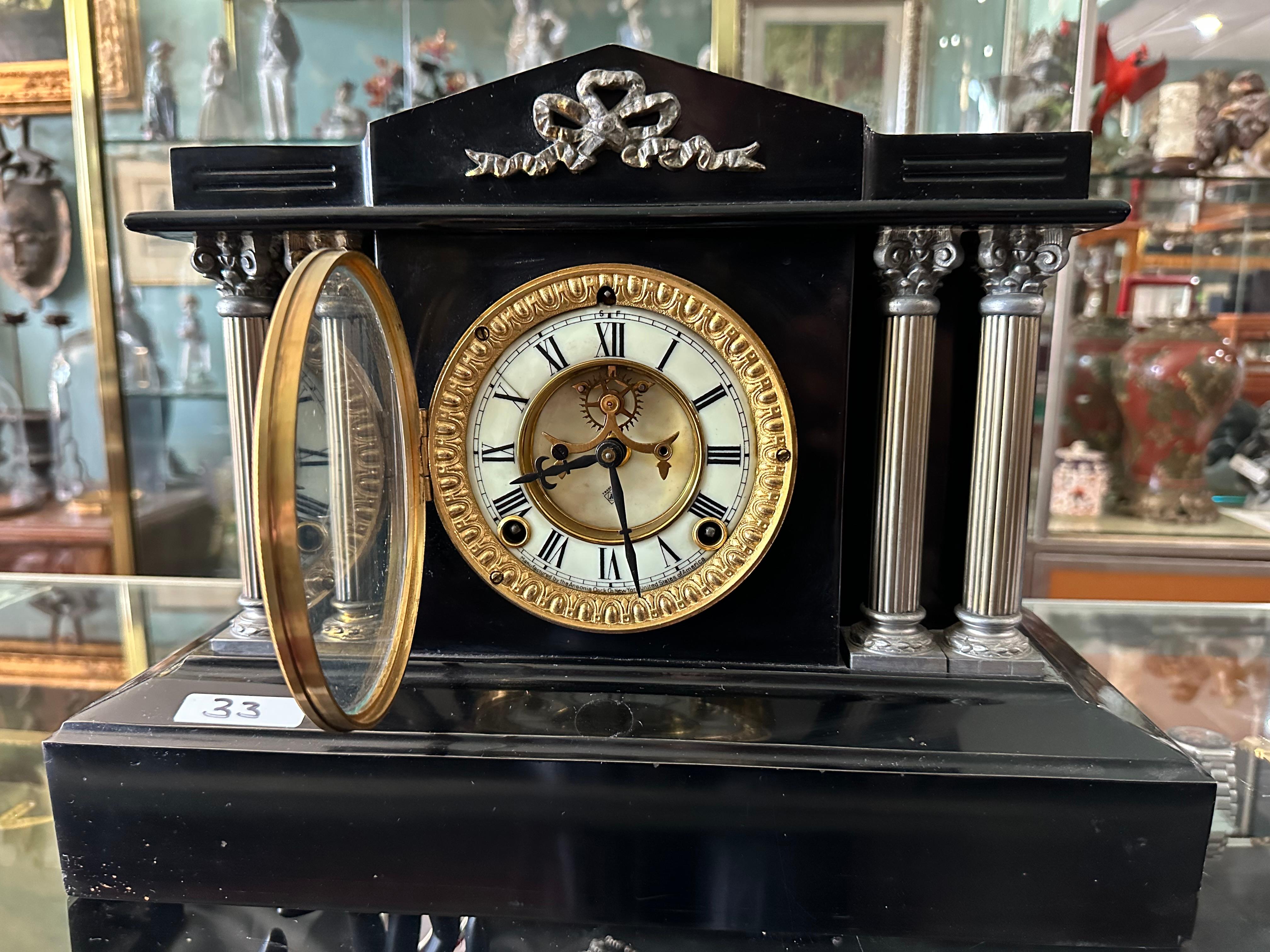 black marble ansonia mantle clock with four pillars 