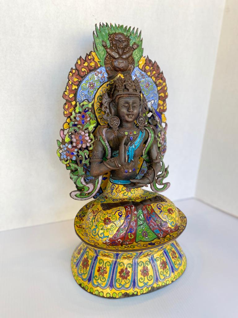 This antique Quan Yin (BUDDHA) is made of metal, hand painted in the cloisonne' style very colorful 
sitting in the legs crossed hand held high for blessings.