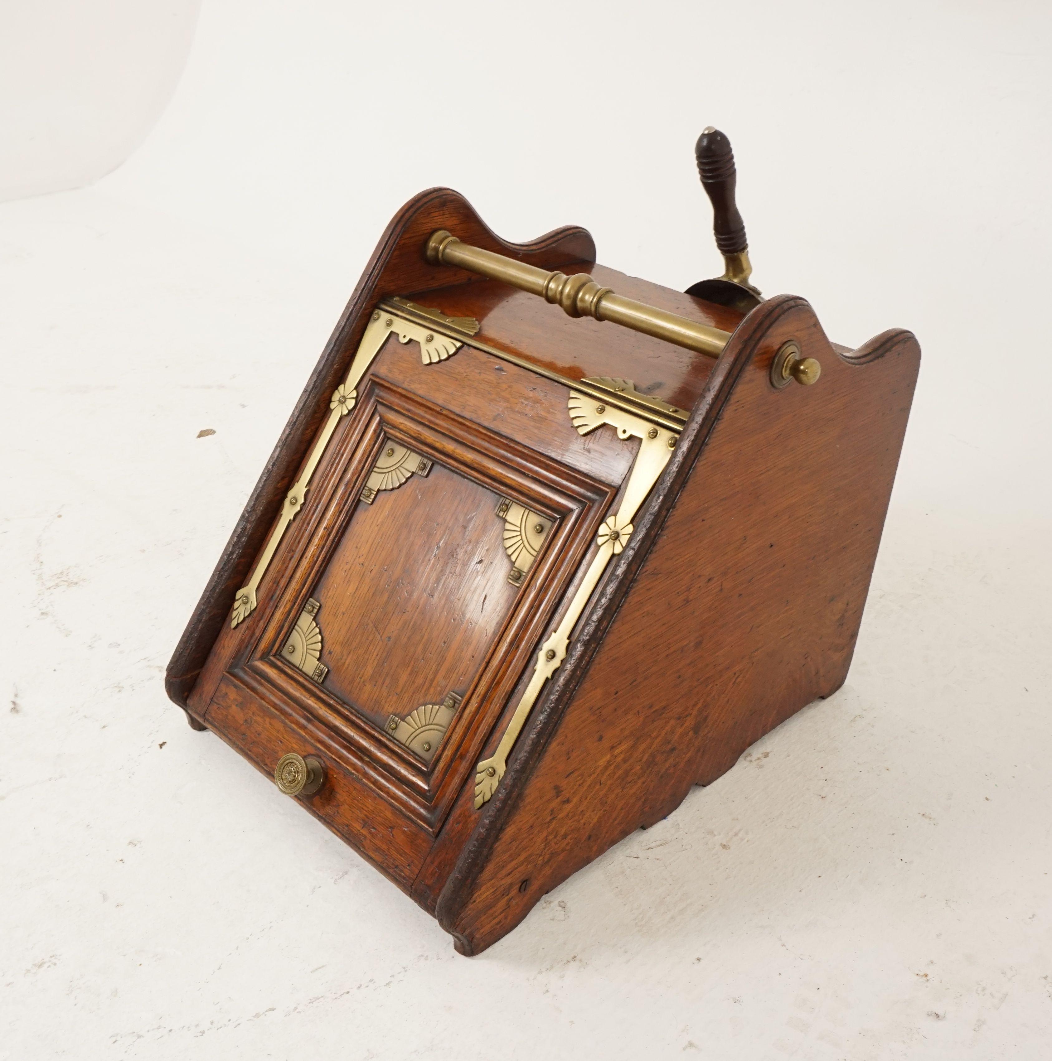 Antique coal box, hod, oak and brass, shovel, metal liner, Scotland, 1890, H139

Scotland 1890
Solid oak
Original finish
Oak top
With sloping front and back
Decorative brass detail on the front, brass hinges
Brass knob on the bottom
Turned brass