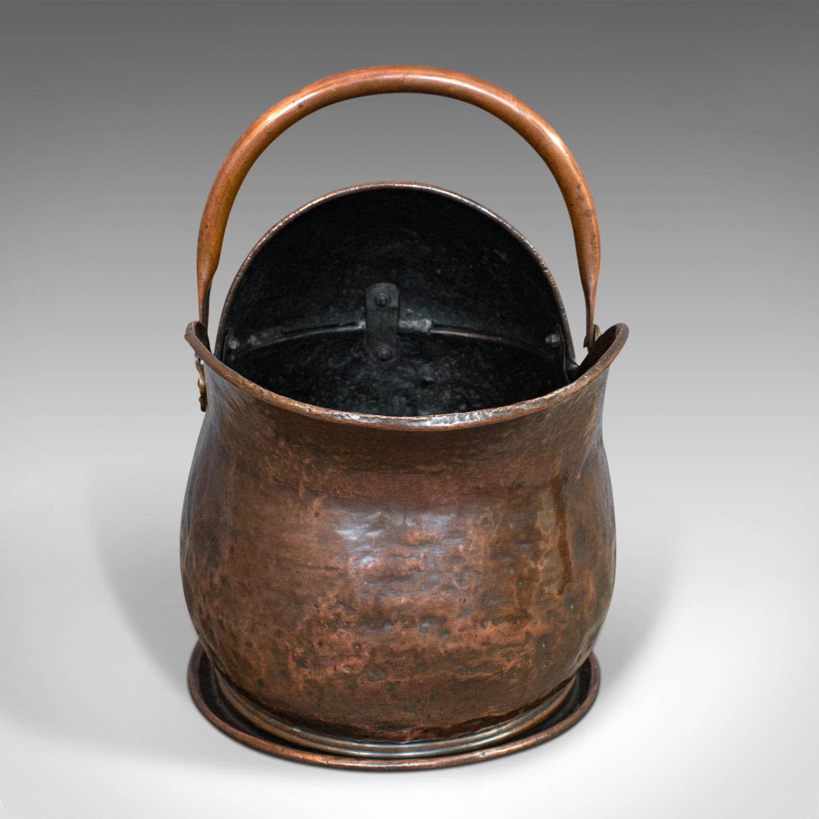 This is an antique coal bucket. An English, copper fireside scuttle, dating to the Victorian period, circa 1870.

Victorian fireside chic
Displays a desirable aged patina
Copper with appealing weathering and tonality

Swivel loop handle with