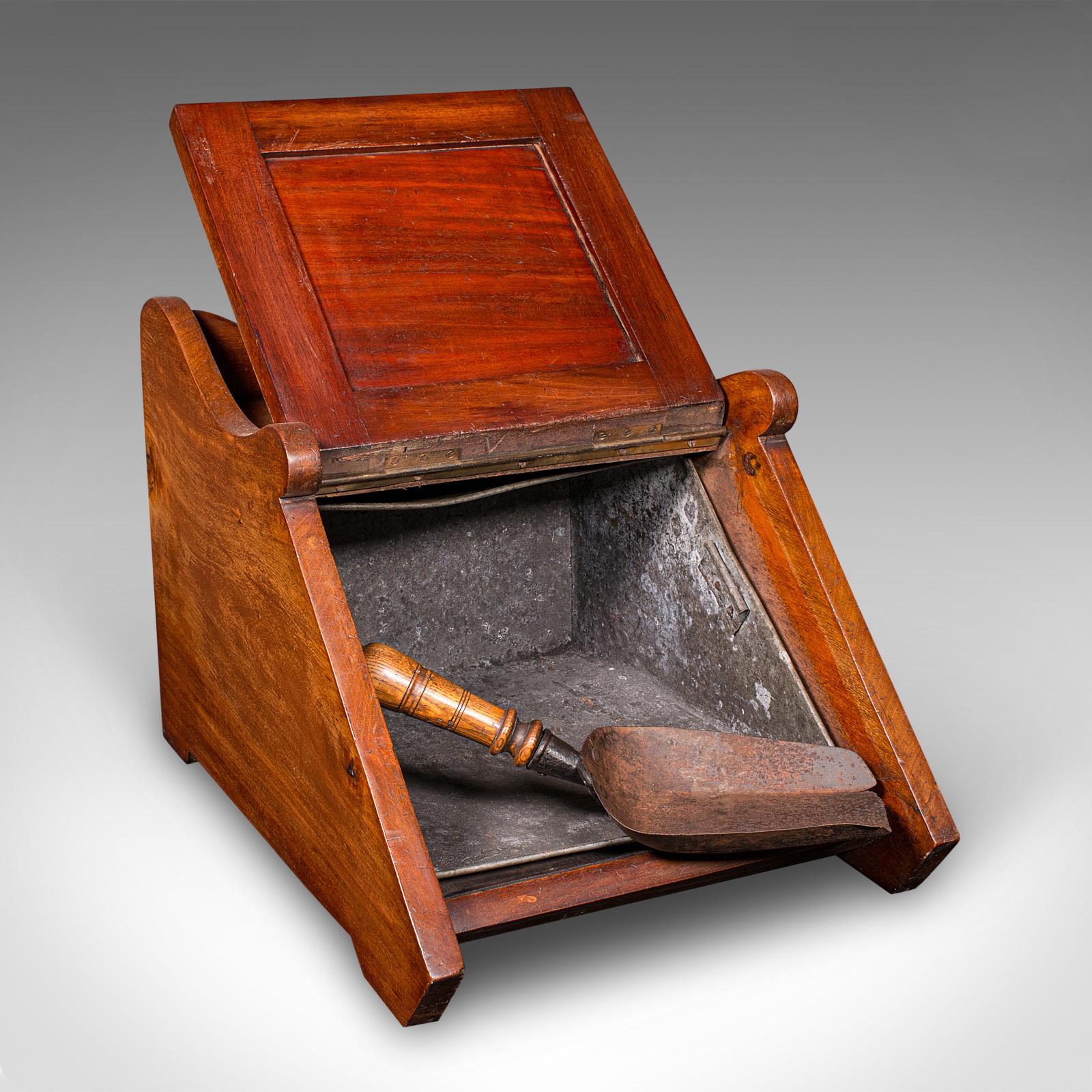 This is an antique coal purdonium. An English, walnut and brass fireside fuel keep, dating to the Victorian period, circa 1870. A fine example of traditional craftsmanship, this handsome piece presents excellent grain interest and enduring