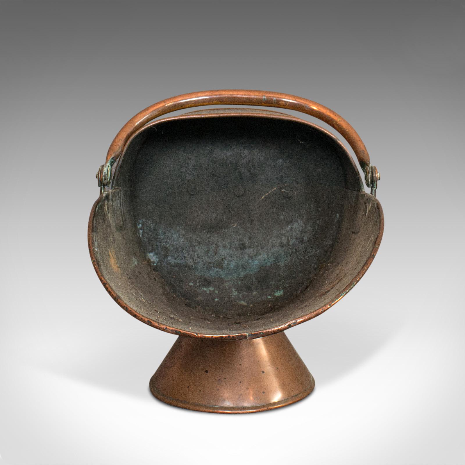This is an antique coal scuttle. An English, copper fireside coal or log bucket, dating to the Victorian period, circa 1890.

Attractive fireside scuttle
Displays a desirable aged patina
Hand-beaten, riveted copper with Fine weathering and