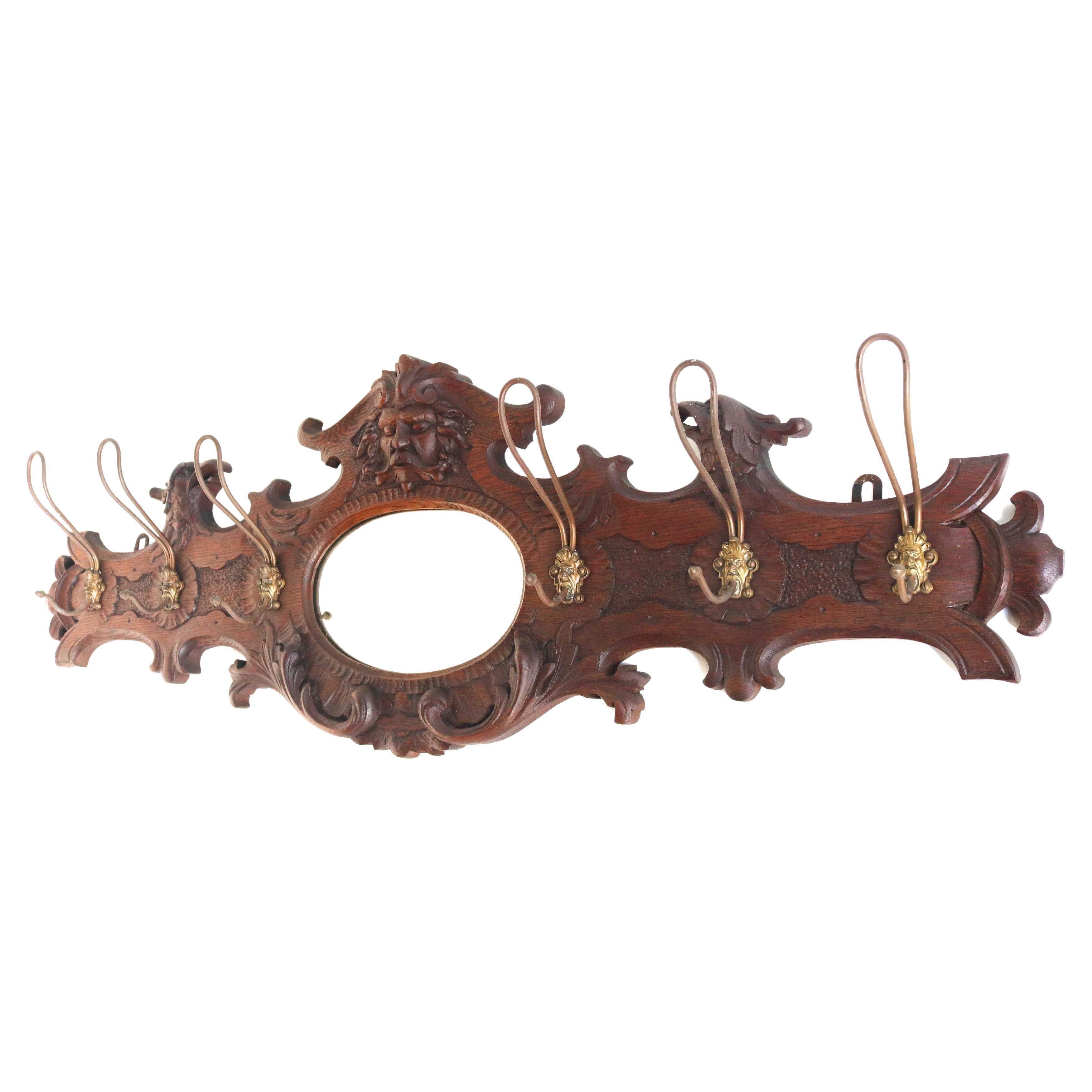 Antique Wood Carved Oak wall hanging coat rack 19th Century Eagle Oval Mirror Carved Face Hat Rack Hand Carved Entryway Hooks 1880s

Beautiful authentic antique piece of craftsmanship for your entrance hall!
A hand carved oak wall hanging coat