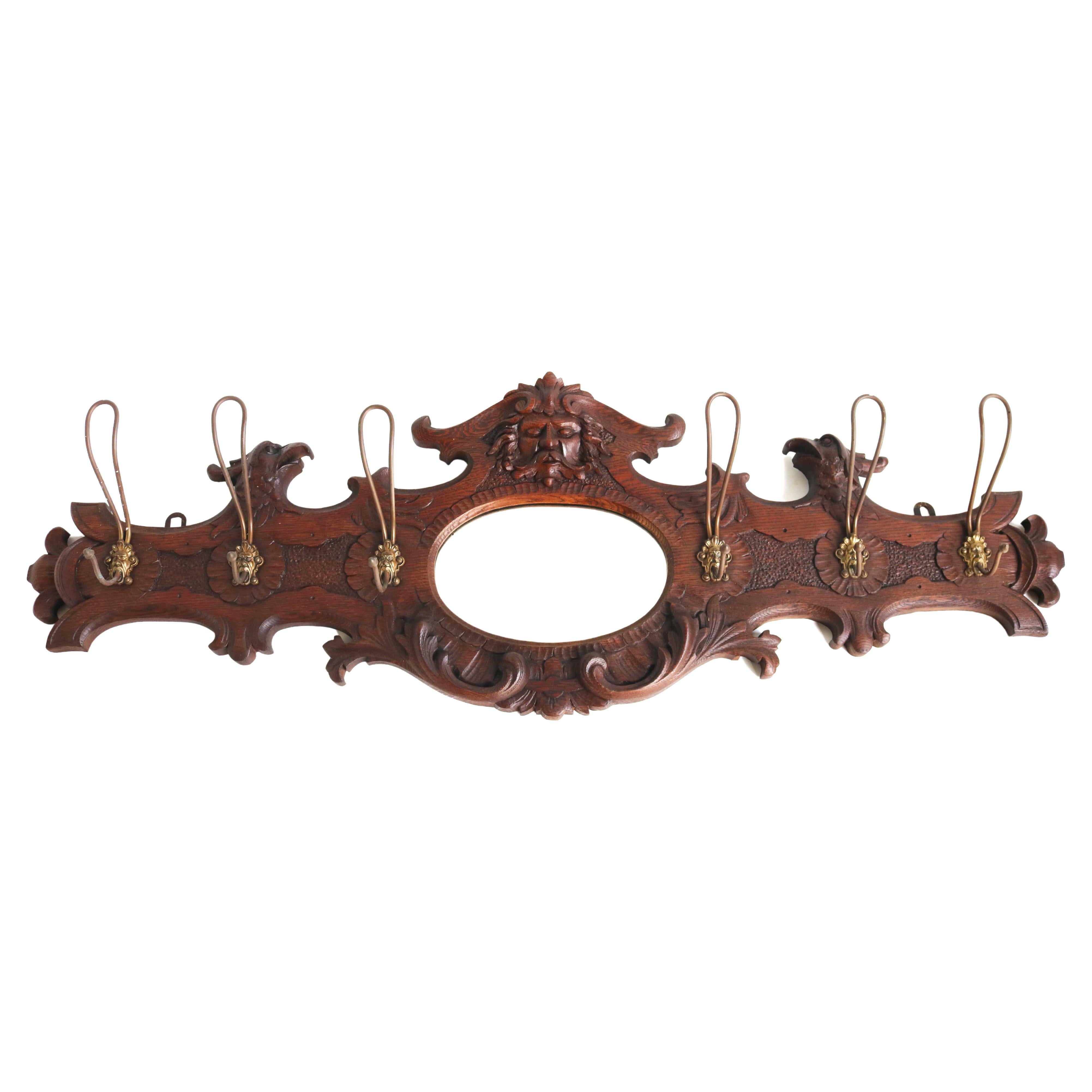Antique Coat Rack Wood Carved Mask and Eagle, Mirror, Brass Hooks 19th Century  For Sale