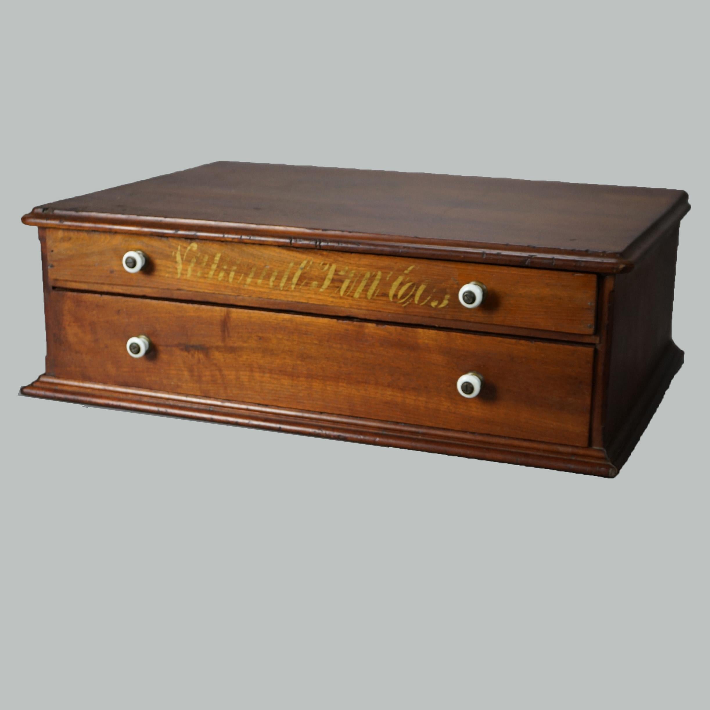 An antique country store spool cabinet in the manner of Coats offers cherry construction with two drawers, one with gilt lettering, c1900

Measures - 7.75