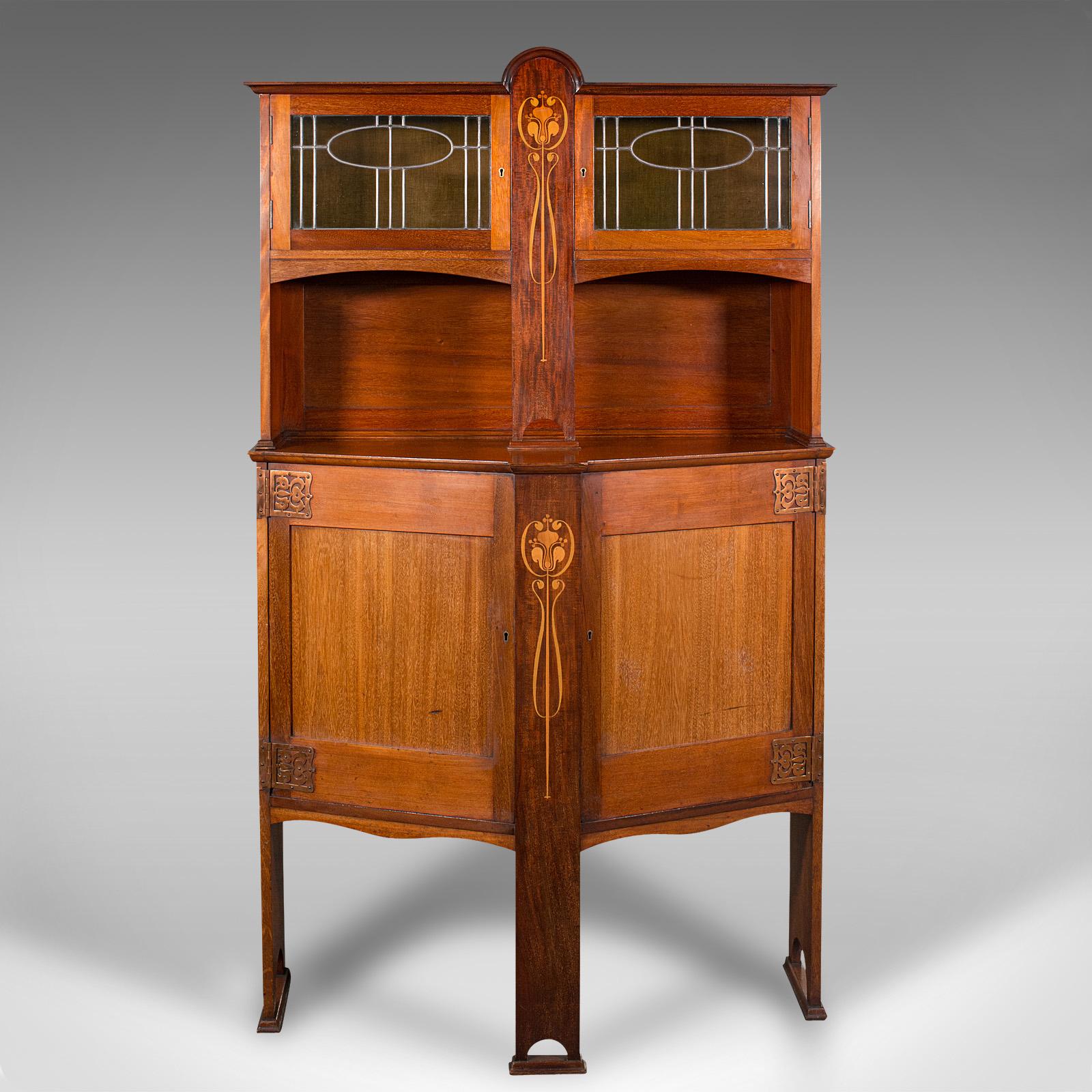 This is a striking antique cocktail cabinet. An English, walnut sideboard cupboard in the Arts & Crafts taste and the manner of Liberty, dating to the late Victorian period, circa 1900.

Utterly dashing cabinetry with superb finish and
