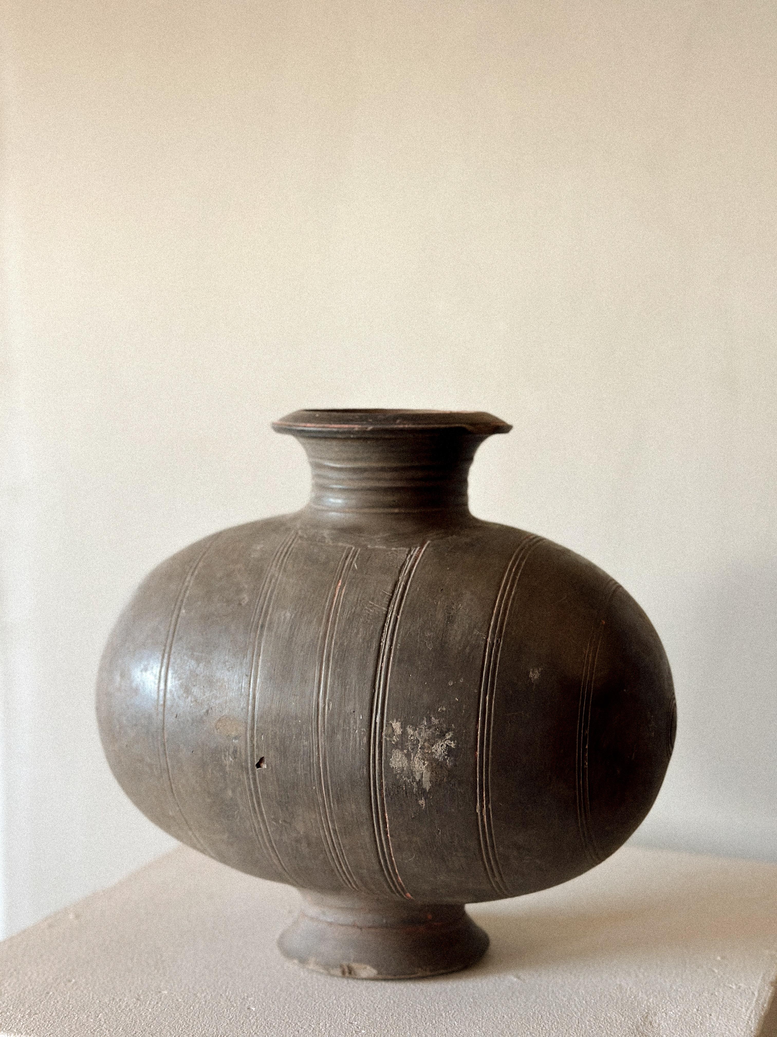 An antique cocoon jar. Earthenware with hints of red color pigments. China, Han period (206 BCE - 220 CE). 