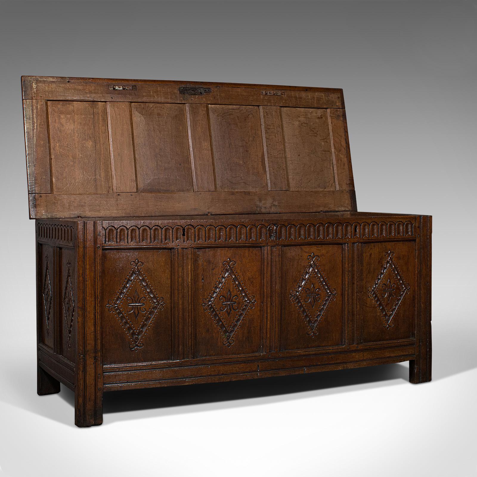 This is an antique coffer from the reign of Charles II dating to circa 1680.

A fine example well carved in English oak, this piece features a quadruple panel top mirrored to the front and rear and complimented by double panelled ends. A typical