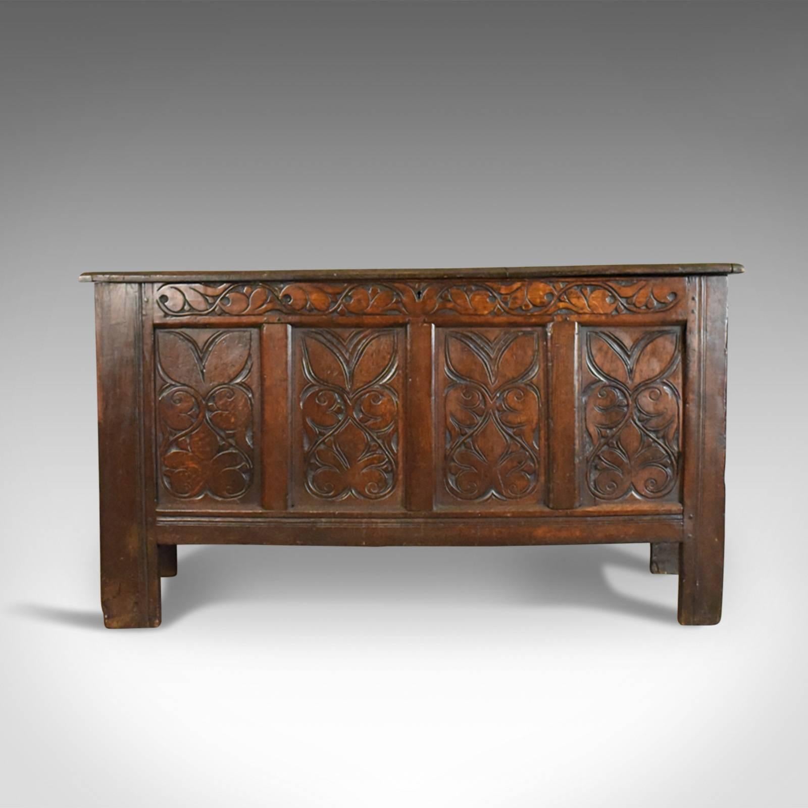 This is an antique coffer, a large English oak chest or early 18th century trunk dating to circa 1700.

Substantial oak chest displaying rich, dark color
Pegged joint construction with a desirable aged patina
Four panel chest with grain interest