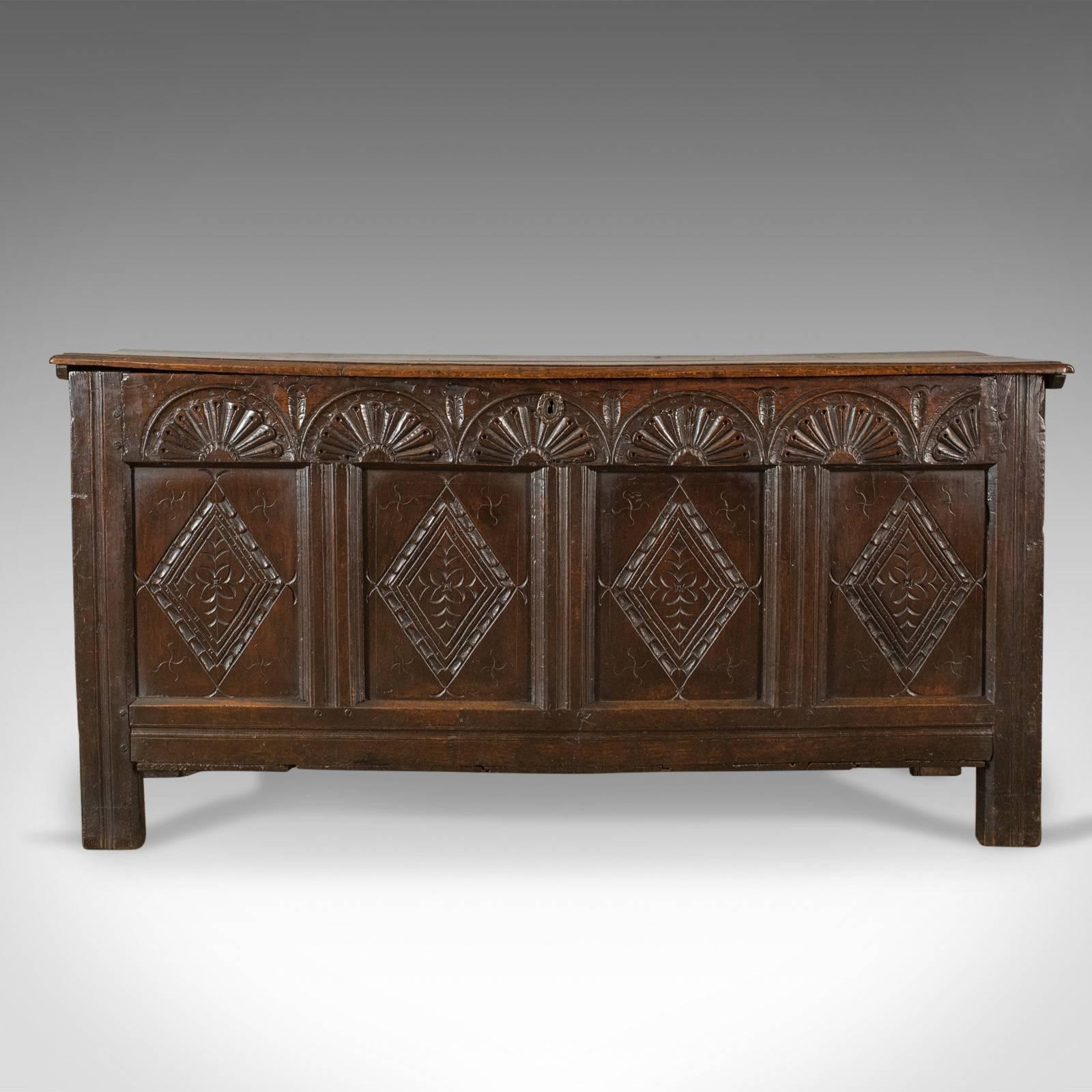 This is an antique coffer, a large, late 17th century, English oak, joined chest. A Charles II trunk dating to circa 1680.

Substantial oak chest displaying rich, dark color
Pegged joint construction with grain interest throughout
Four panel