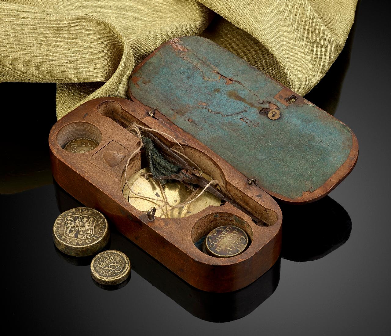 A rare set of antique 17th century merchant’s coin scales and weights in their tailor-made box. Decorated with three Tudor roses and a stippled border.

The Antique box is approximately 5 inches in length; the hand held scales are steel with two