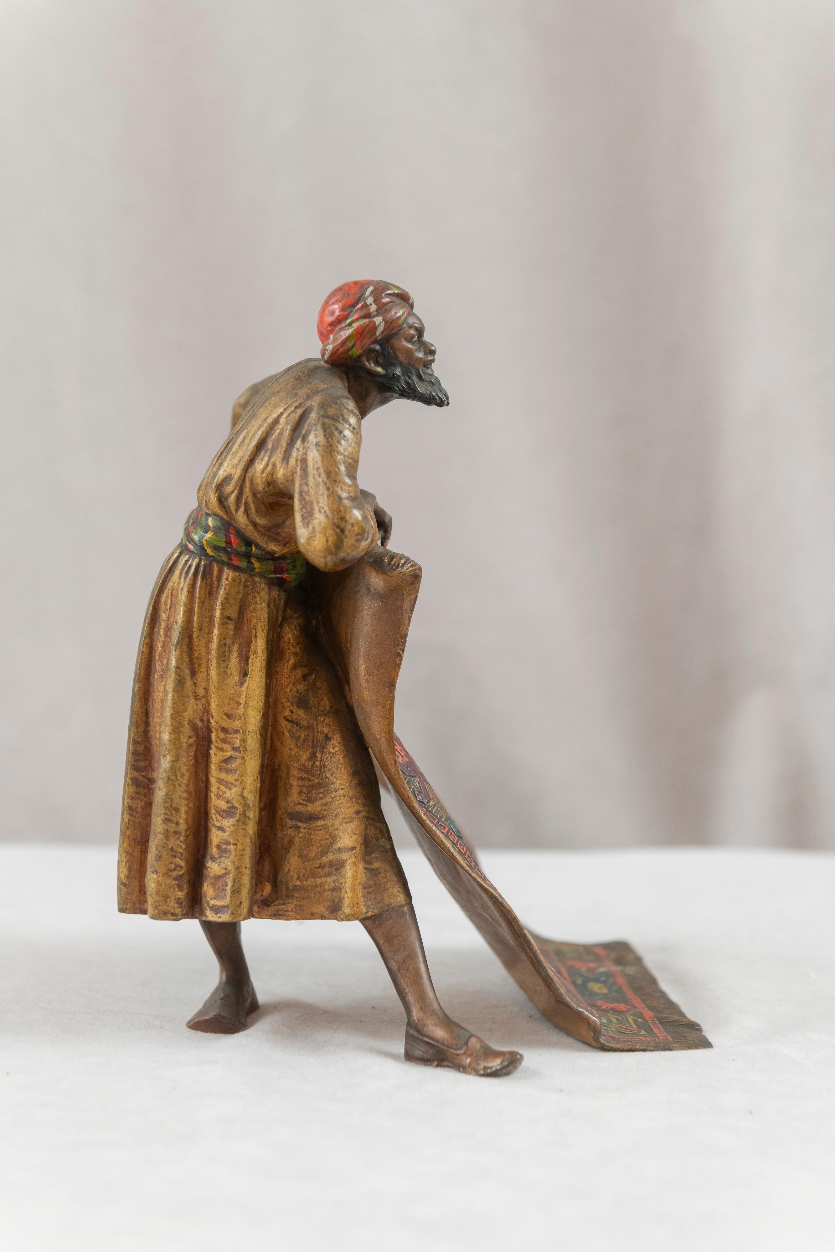 A nicely cast and meticulously cold painted figure of an Orientalist rug merchant. A popular theme for the collector, or anyone with an eye for quality. Marked 