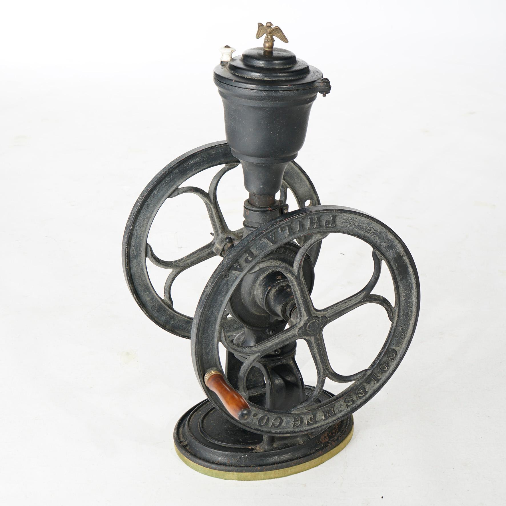 An antique country store countertop coffee grinder by Coles Mfg. Co., Phila, PA offers cast iron construction with eagle finial and maker embossed on grinder wheel as photographed, c1900

Measures- 31''H x 21''W x 15.5''D.

Catalogue Note: Ask about