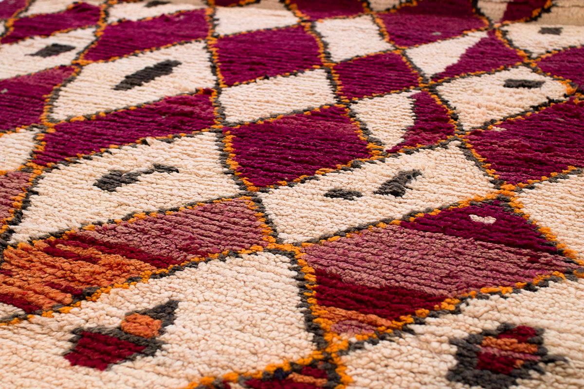 Collectible antique vintage Moroccan shag rug in excellent condition. This is a rare and unique example due to its unusual tribal design. Featuring an irregular geometric diamond pattern of alternating deeply saturated violet and creamy natural