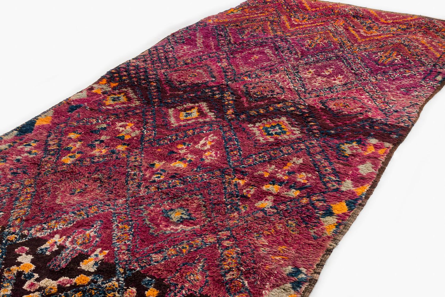 Collectible antique vintage Moroccan shag rug in excellent condition. Featuring a geometric diamond pattern over a deeply saturated violet or aubergine purple background. The jewel-tone design has bright reds that appear to glow, evoking an almost