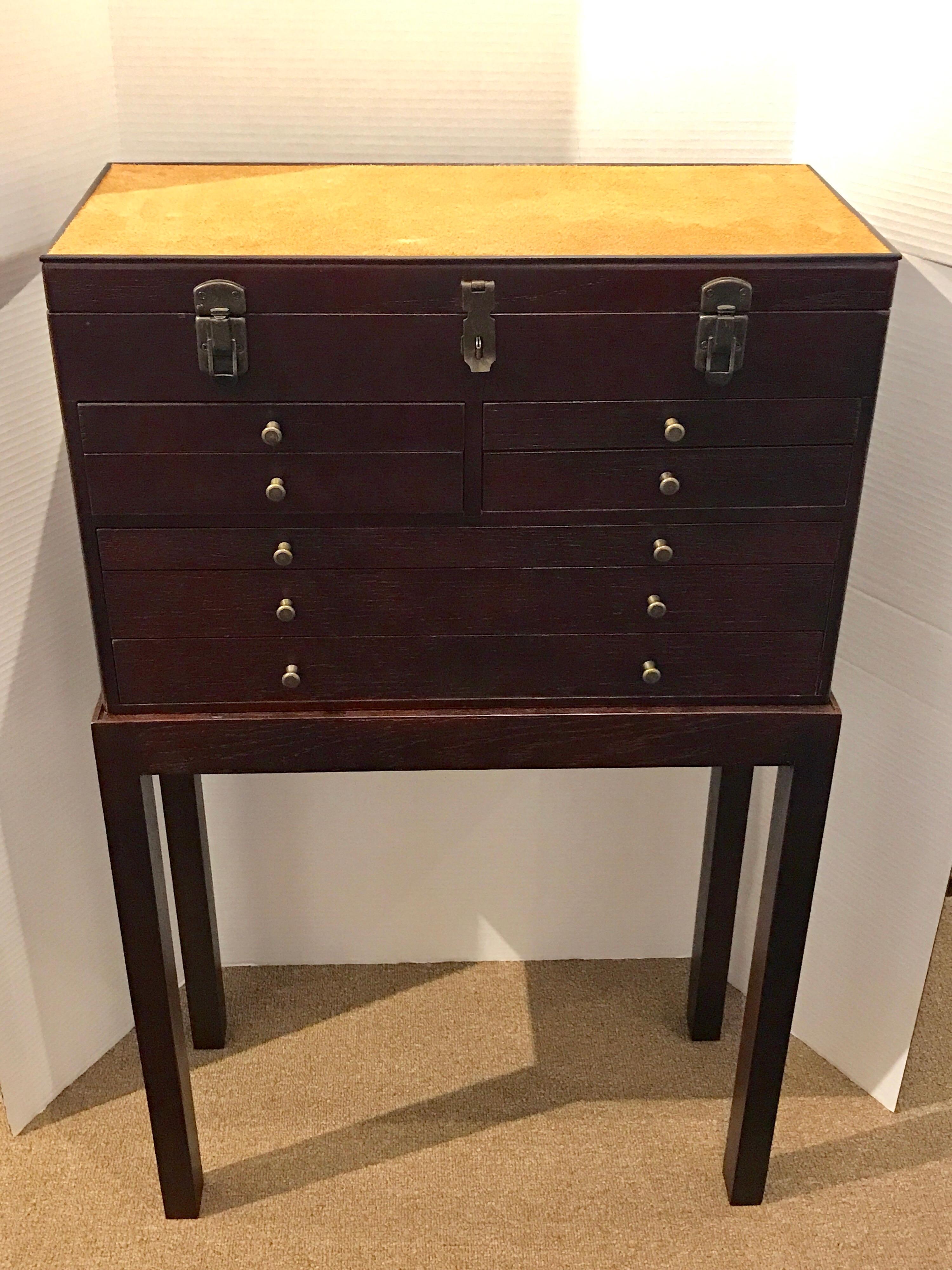 Antique Collectors cabinet on stand, of rectangular form with inset suede lift top, over a locking case of four 11