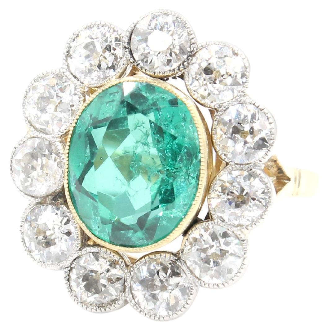 Unique Antique cluster ring circa 1910. 

The ring is completely made of gold 18 Karat. The body of the ring and the setting of the emerald is made in yellow gold and the setting of the diamonds is made of white gold. 

The emerald is a Colombian