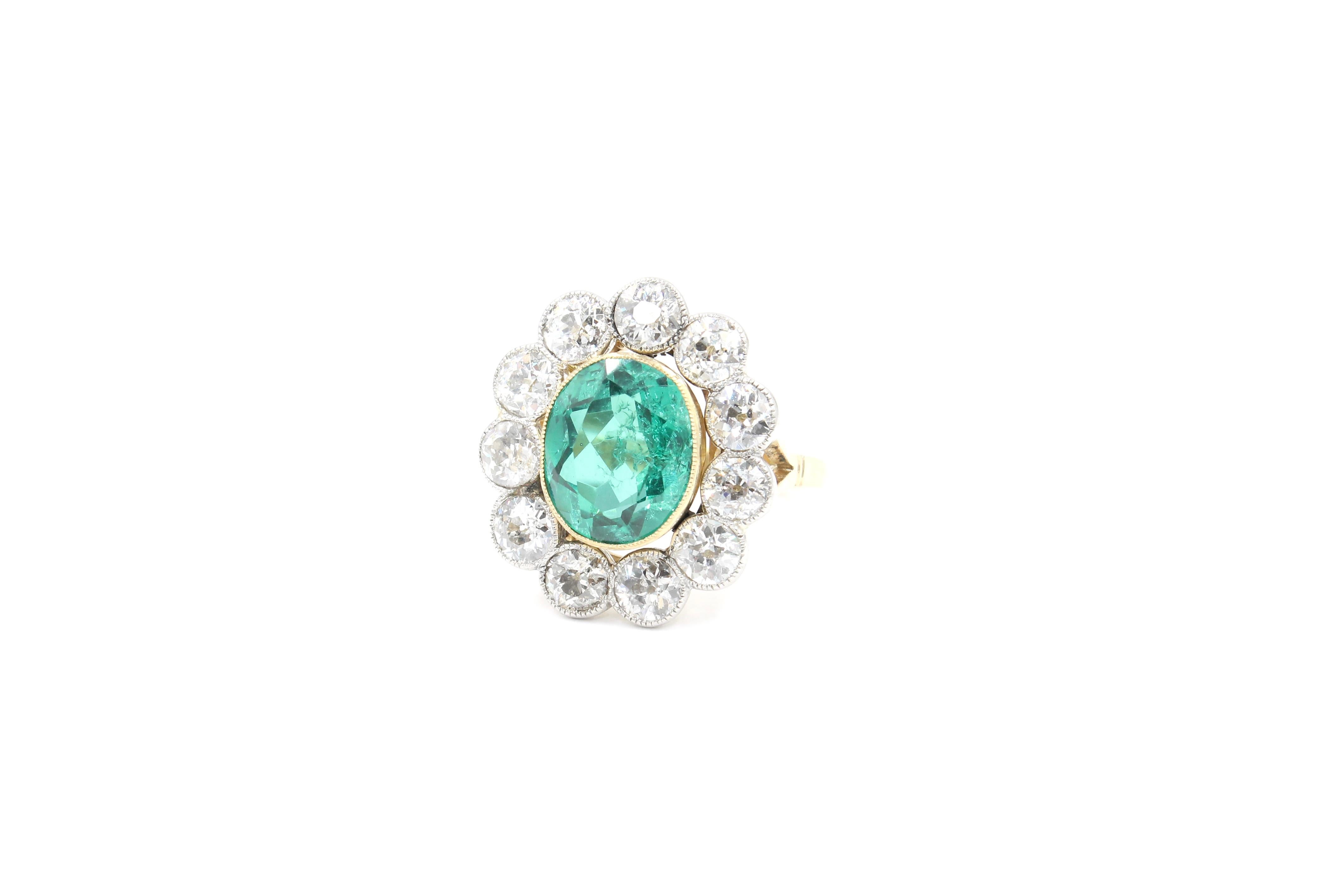 Oval Cut Antique Colombian Emerald (+/- 2.90 Carats) and diamonds cluster ring circa 1910