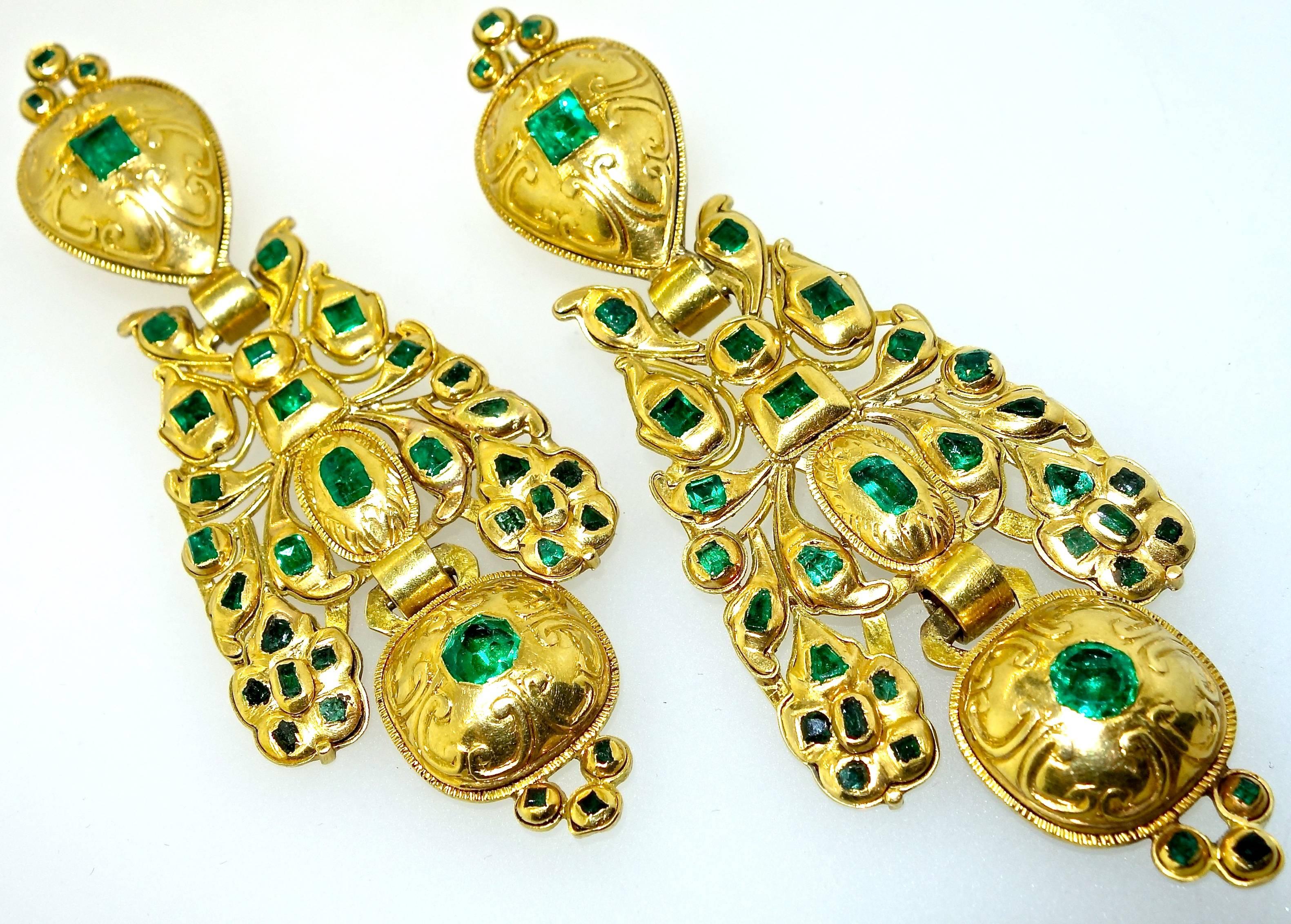 18K yellow gold and just under 4 inches long, the natural  old cut Colombian emeralds weigh approximately 4 cts and display a bright 