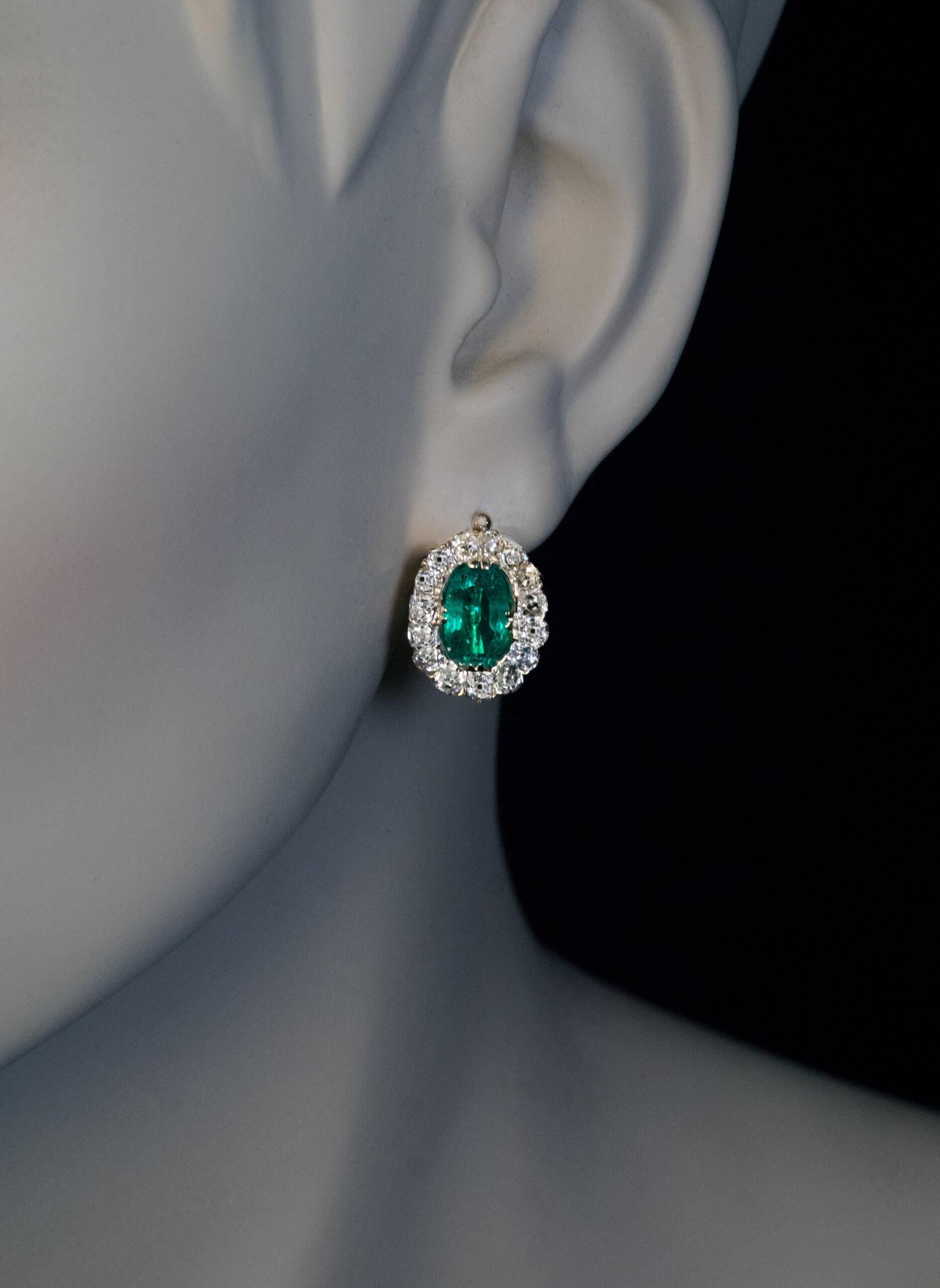 Russia, circa 1880.  These classic Victorian era 14K gold cluster earrings feature a well matched pair of excellent Colombian emeralds (1.96 carats and 1.67 carats). The emeralds are surrounded by chunky old mine cut diamonds.  Combined emerald