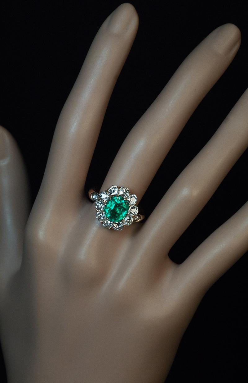 Made in Vienna, Austria in the 1890s.
This classic gold cluster ring from the Victorian era features an oval Colombian emerald of excellent color, clarity and saturation. The emerald is surrounded by sparkling old European and old mine cut diamonds.