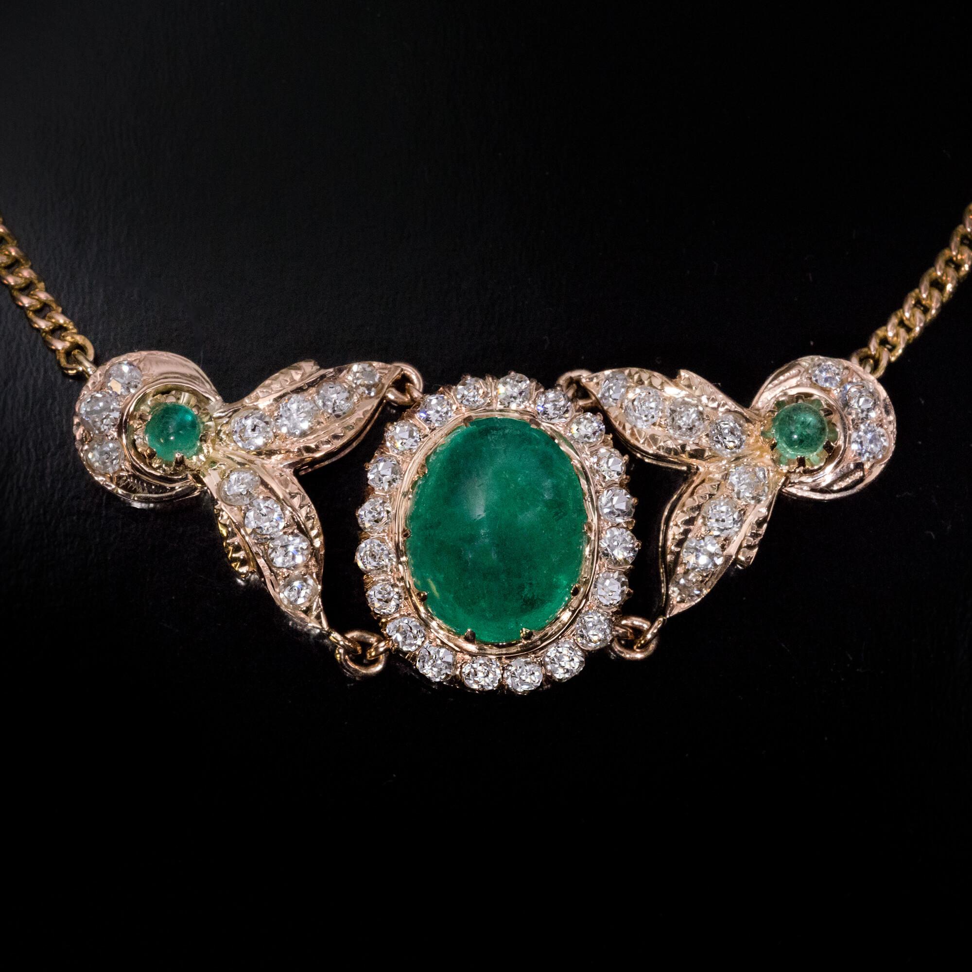 Russia, circa 1880s-1890s.  This 14K gold necklace features a 5.40 ct cabochon cut Colombian emerald of a very nice ocean blue green color framed by sparkling old mine cut diamonds. The principal emerald is flanked by a pair of diamond-set half moon