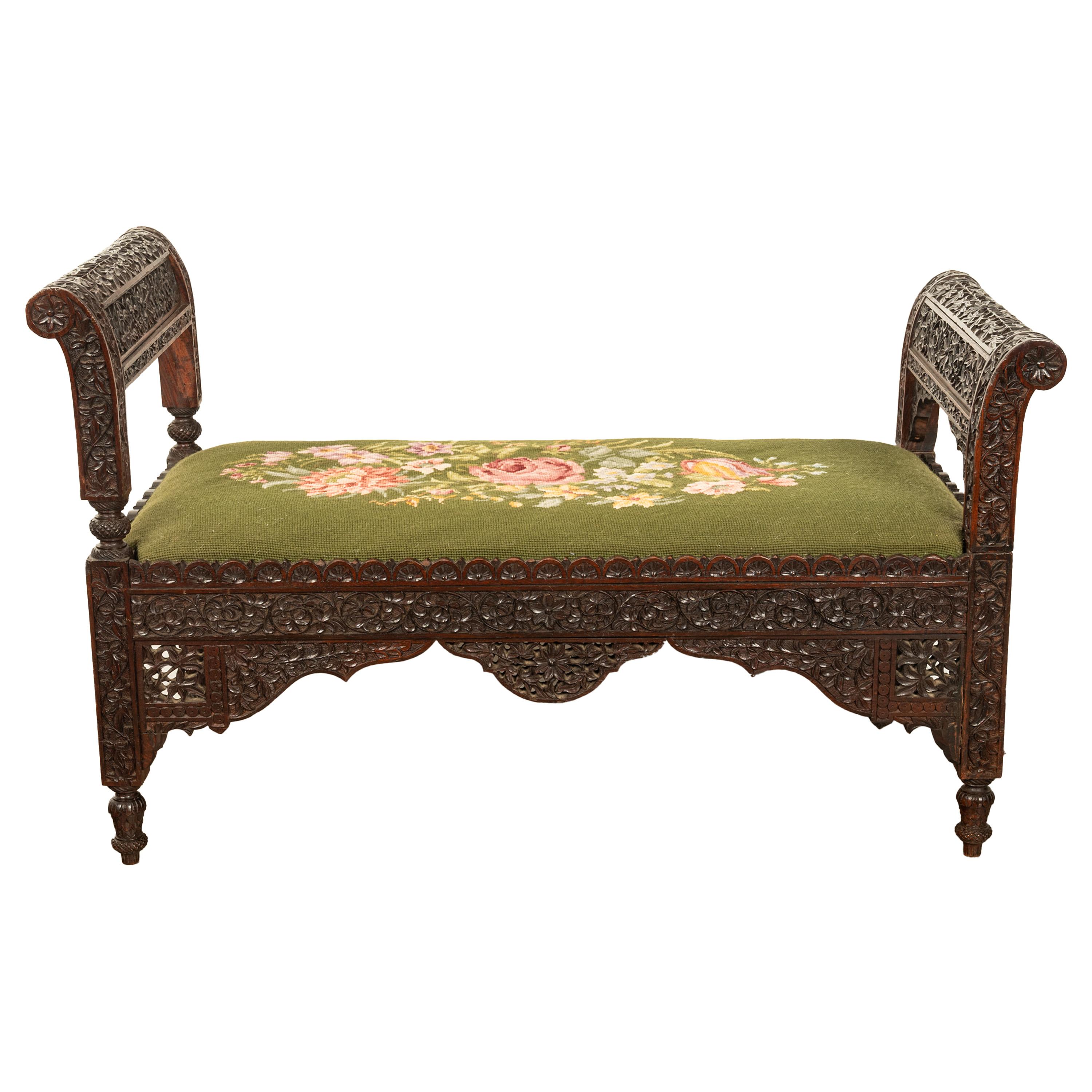 A very good antique Anglo-Indian carved rosewood window seat, bench, circa 1860.
The bench being very finely carved from rosewood, with curved rests at each side & carved and pierced and with rosettes and scrolling foliate. The seat with an