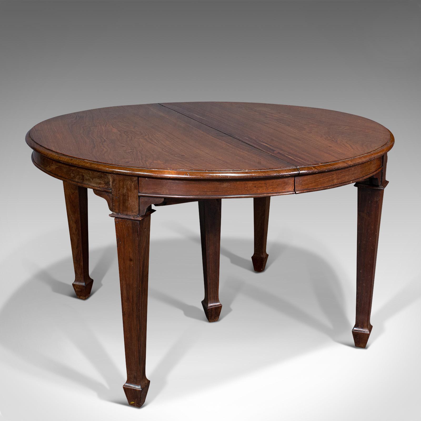 This is an antique colonial Campaign table. An Indian, solid rosewood dining table with leaf extension, dating to the Victorian Empire, circa 1890.

Delightful example of a Campaign dining table – a truly rare and interesting piece
Displays a