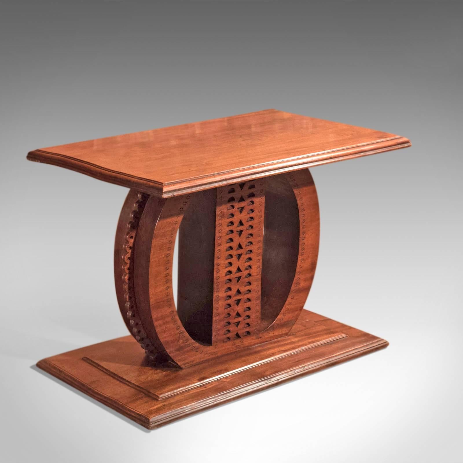 This is an antique, 19th century hardwood table.

Of immense weight, carved from a single piece of hardwood, this exotic piece makes for an interesting side or lamp table.

The stepped plinth base mirrors the top bringing symmetry to the piece