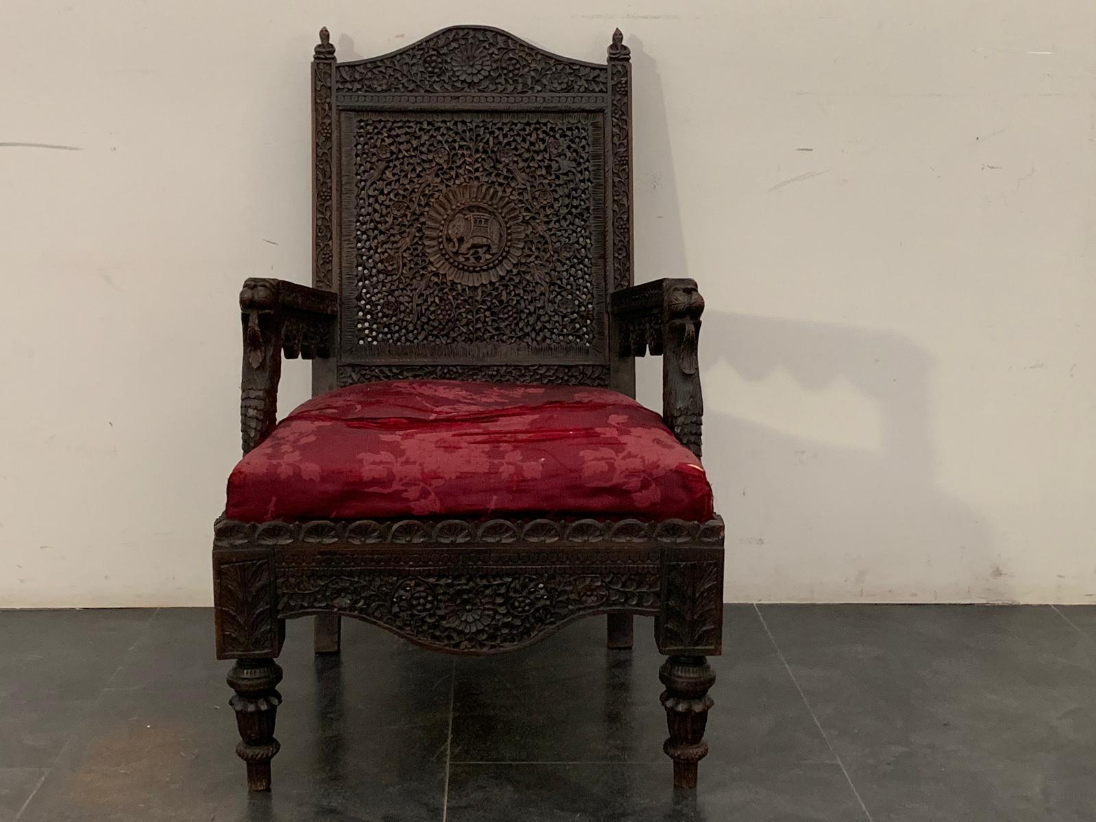 British Indian Ocean Territory
Anglo Indian colonial armchair, carved on teak wood, under the armrests stand out 2 lion heads, on the central rose window of the backrest is depicted an imperial elephant, on the back at the sides of the knobs the