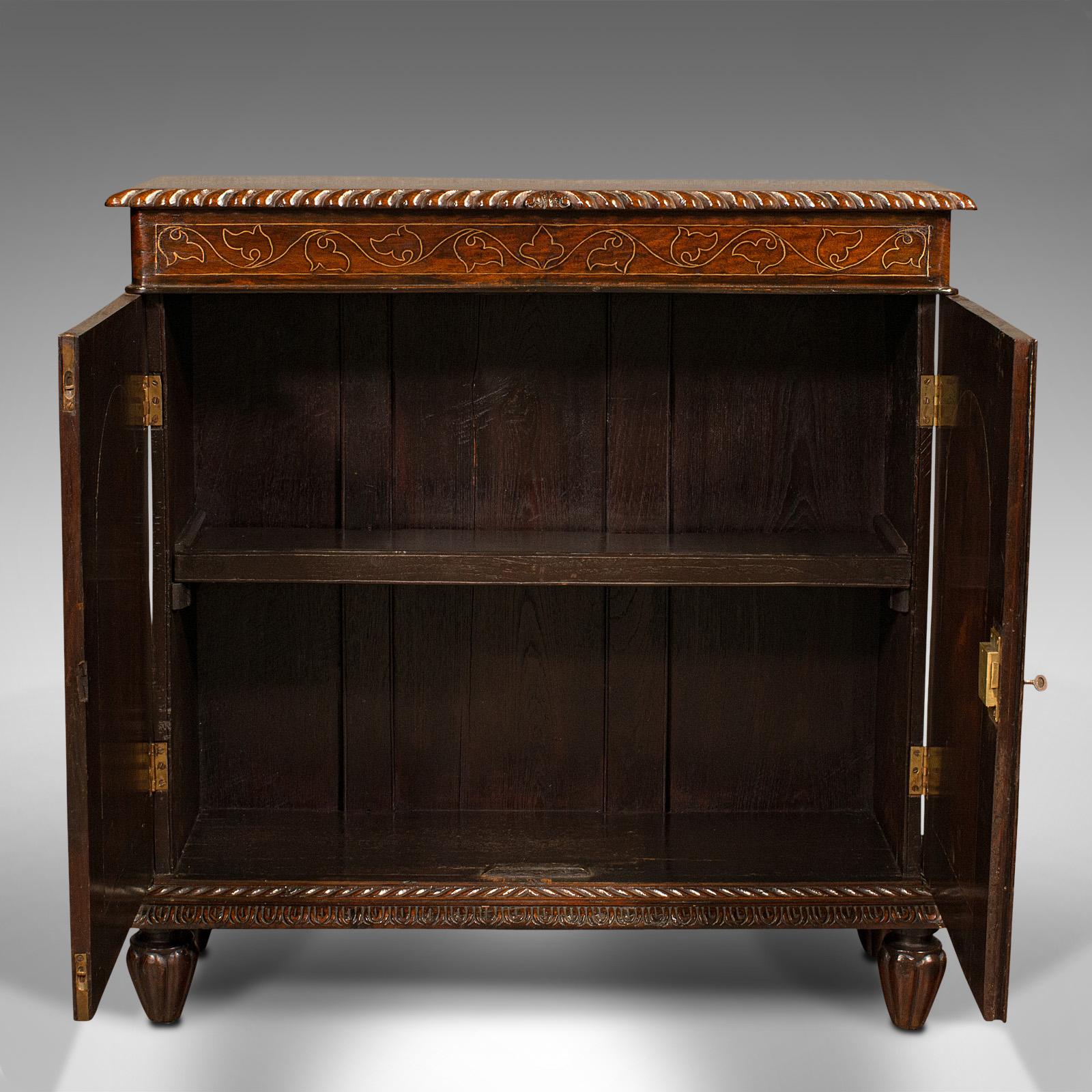 This is an antique colonial side cabinet. An Anglo-Indian, rosewood drinks or hall cupboard, dating to the William IV period, circa 1830.

Of striking appearance, with deep colour and shimmering brass inlays
Displaying a desirable aged patina and