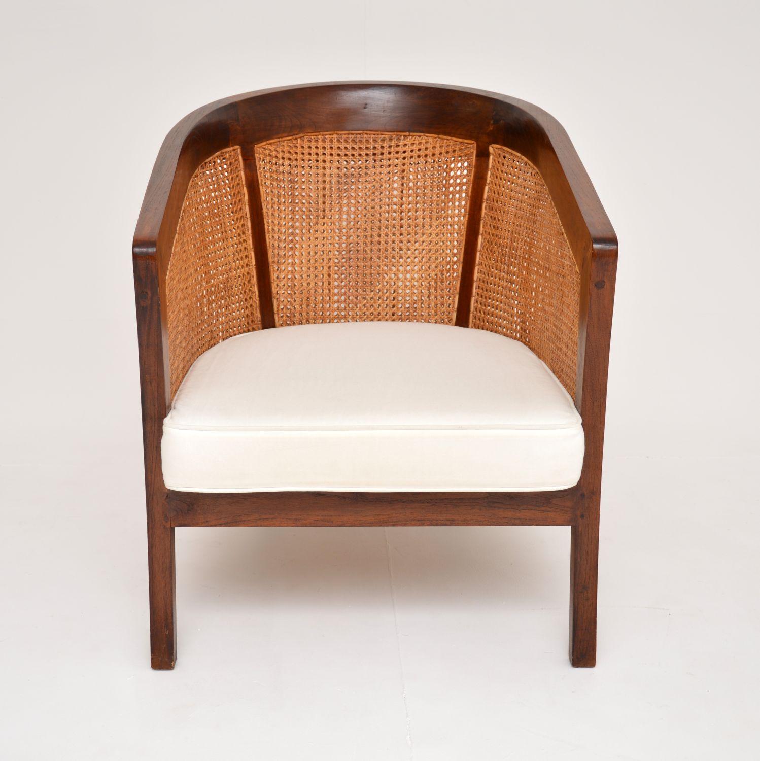 A beautiful antique colonial style armchair in solid teak. This was possibly made in southern or east Asia, it dates from around the 1950-60’s.

The quality is amazing, with a beautifully sculpted frame with fine cane rattan on the seat and all