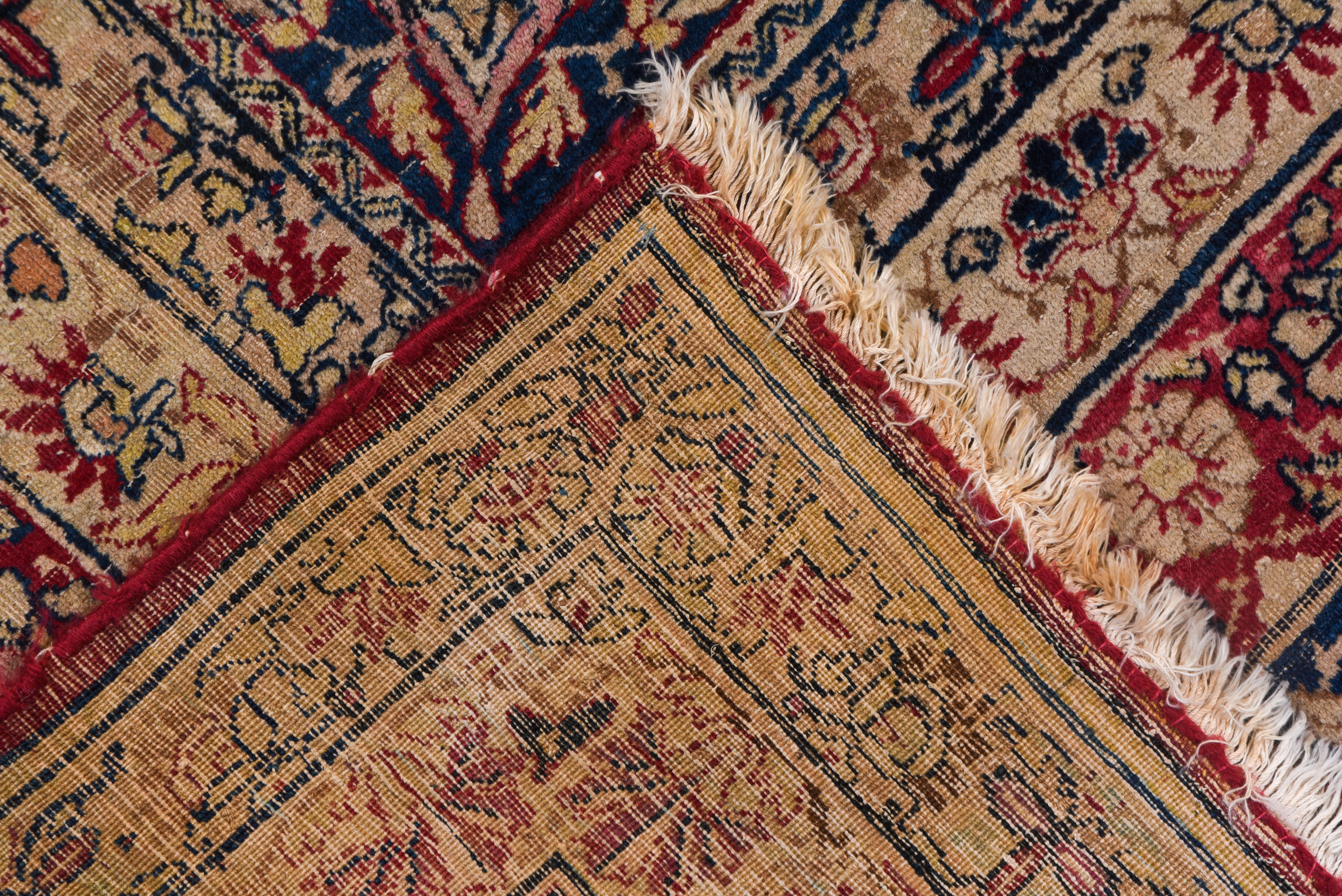 'Lavar' quality refers to SE Persian urban Kermans with particularly fine weaves, elaborate and well-executed designs, and particularly wide color palettes. This carpet certainly qualifies with a sand field displaying a round, eight lappet-lobed