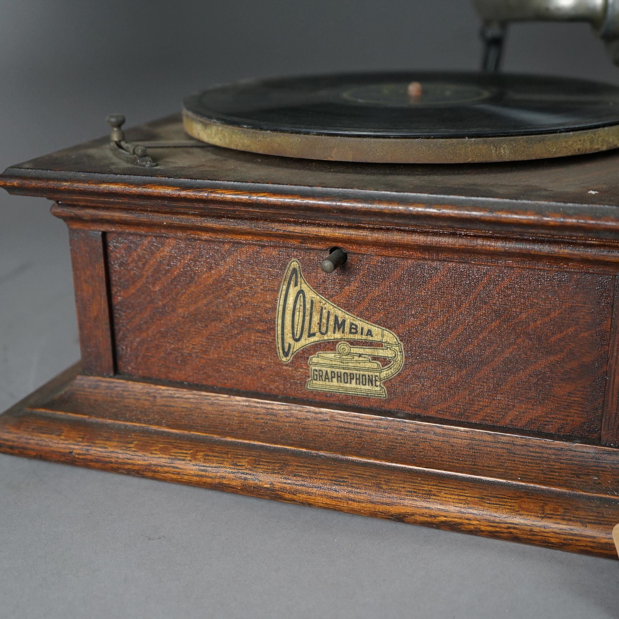 An antique Columbia Graphophone Victor Victrola disc player offers quarter sawn oak case with exterior green tulip for horn; very good working condition; maker label as photographed; c1910

Measures - 26.5